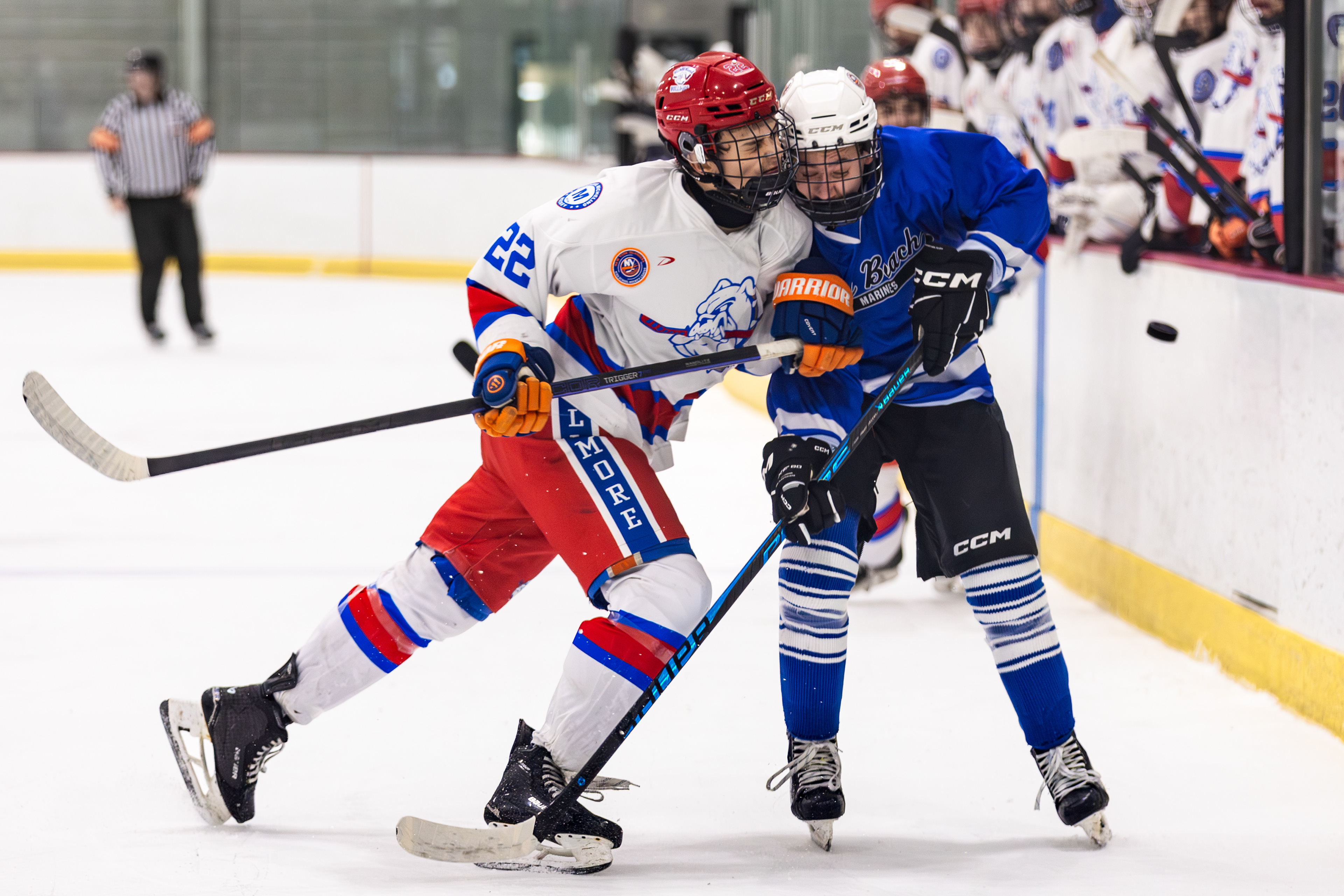 Bellmore-Merrick Bulldogs forward Lucas Lucchi (22) body checks a Long Beach Mariners player during the USA Hockey state tournament semifinal at SUNY Broome Ice Center on March 1, 2026, in Binghamton, N.Y.
