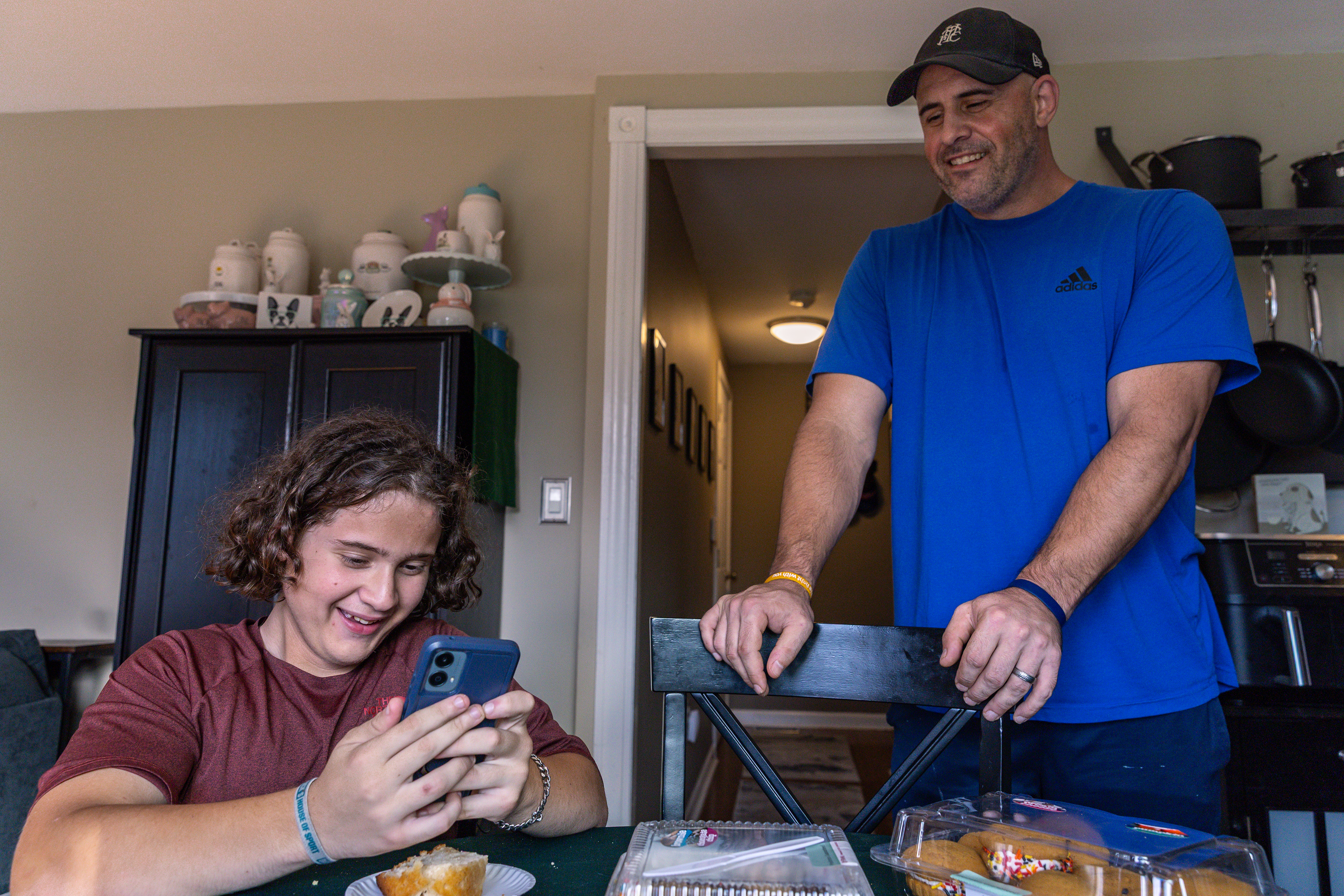 Jamie and Myles share a laugh over a photo of Myles’ hair from a recent hockey game.  From the moment Myles was born, he and Jamie have shared a unique bond. The two can only describe their relationship as “untraditional,” moving beyond the traditional father-son relationship to best friends.
