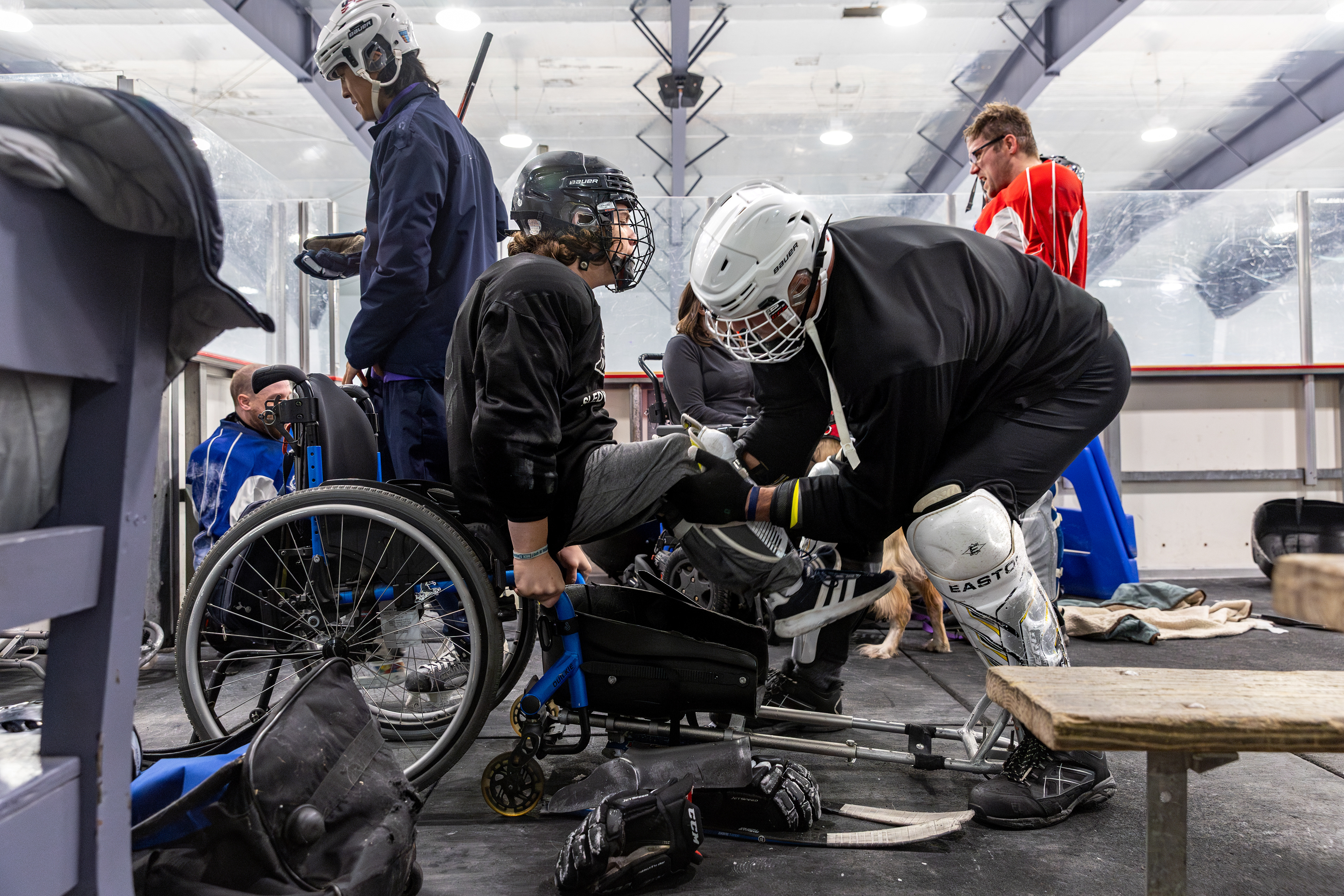 After practice, Jamie helps Myles transition from his sled back into his wheelchair.   For Jamie, advocating for Myles is simply part of being a father. He’s committed to ensuring nothing stands in the way of Myles’ passions and works tirelessly to foster every opportunity for him.  “It's just your job,” Jamie says, “It allows him to maintain nativity and niceness in the world. And if that's a sacrifice you gotta make to advocate, no matter how ruthless or obnoxious or whatever it might be, it allows him to continue to be a child.”