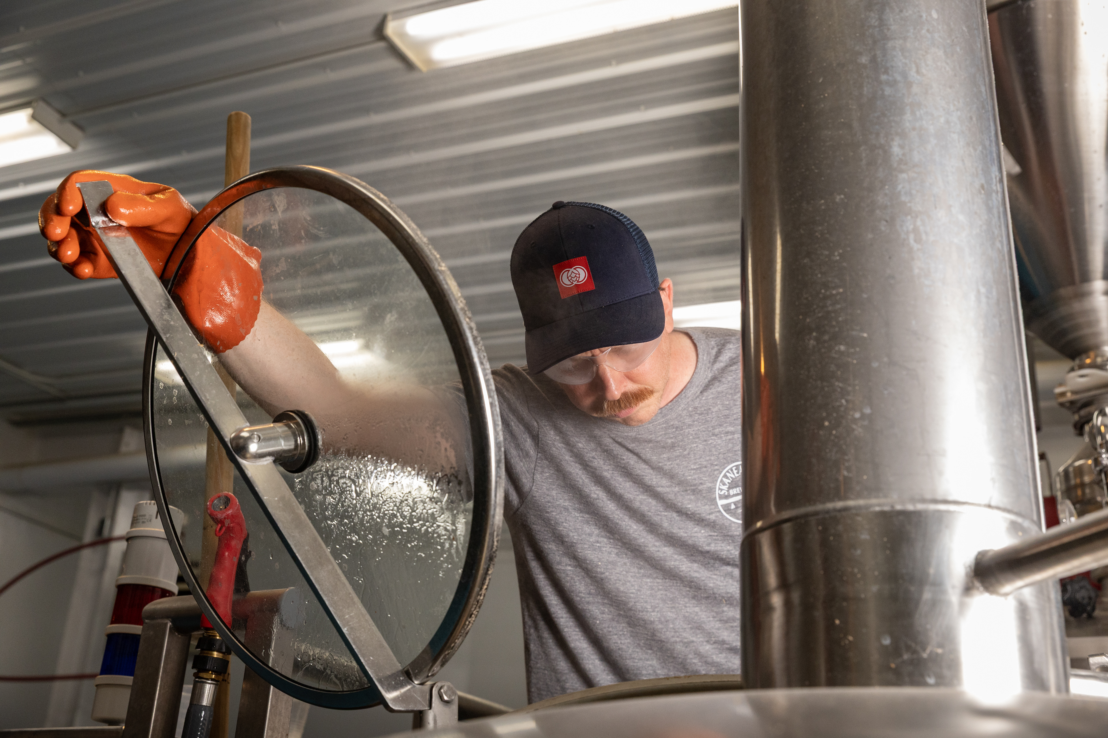Brewer Chris Watson spends a quiet Friday morning brewing a batch of IPA at Skaneateles Brewery. A former musician and medical professional, Watson joined the brewery four weeks ago, taking the next step in turning his passion for beer into a profession that blends science, creativity, and a little bit of danger. 