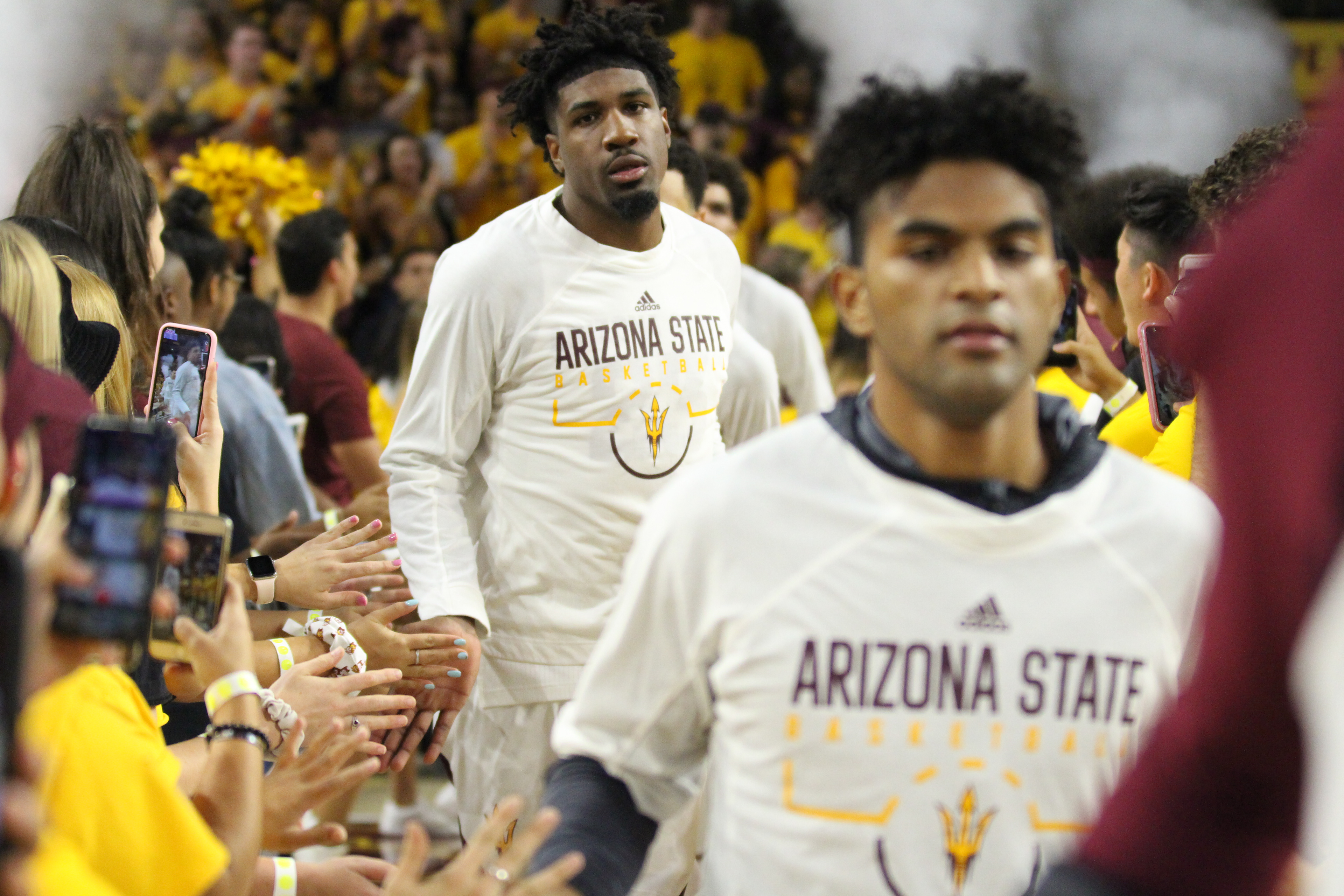 Arizona State forward Romello White (back) high-fives fans as he makes his way onto the court for a game against Central Connecticut State on Nov. 14, 2019, at Desert Financial Arena in Tempe, Ariz.
