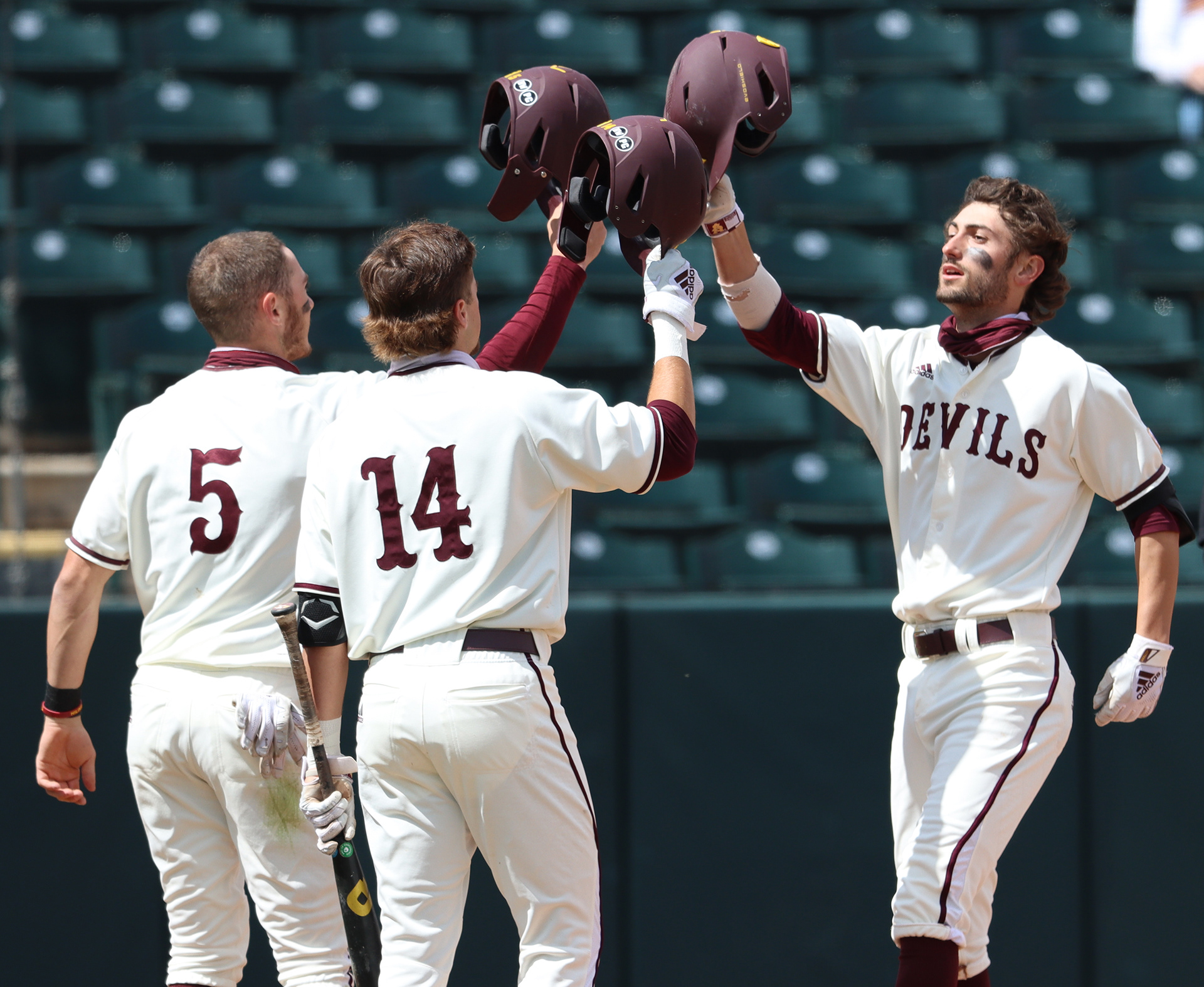 Arizona State shortstop Drew Swift (right) is greeted by teammates Joe Lampe (5) and Hunter Haas (14) after hitting a home run in a game against UNLV on March 16, 2021, at Phoenix Municipal Stadium.