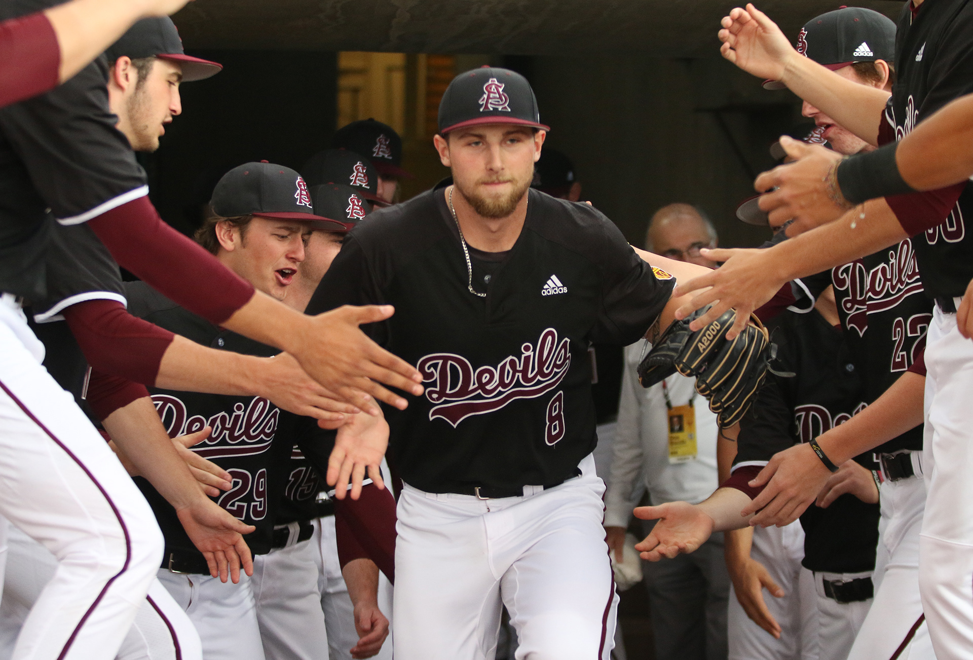 Arizona State pitcher Alec Marsh runs through a tunnel of teammates as he takes the field for his start against Oregon State on April 12, 2019, at Phoenix Municipal Stadium.
