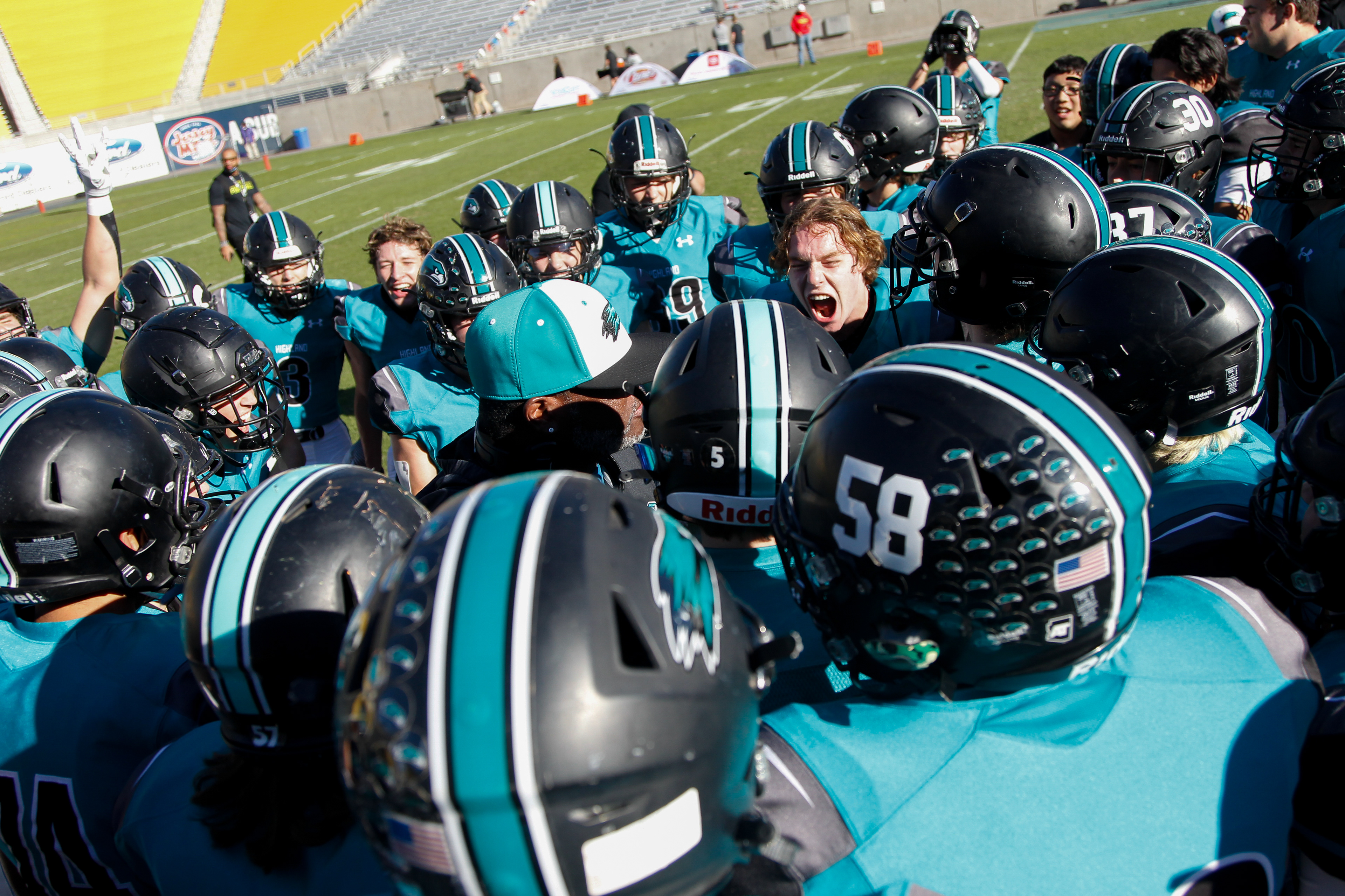 Highland High School football players celebrate their 31-10 victory over Chaparral in the AIA 6A State Championship on Dec. 11, 2021 at Sun Devil Stadium in Tempe, Ariz.