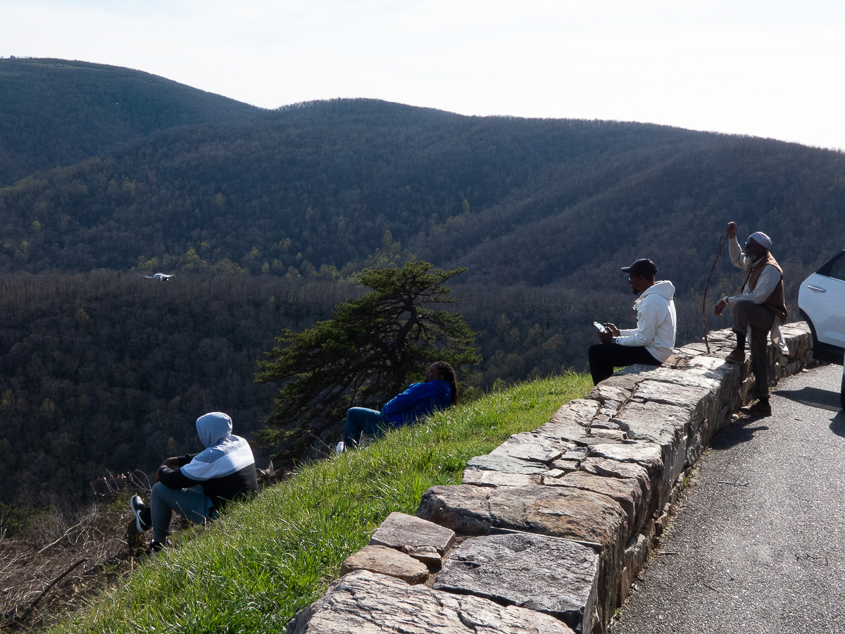 Family siting by hill