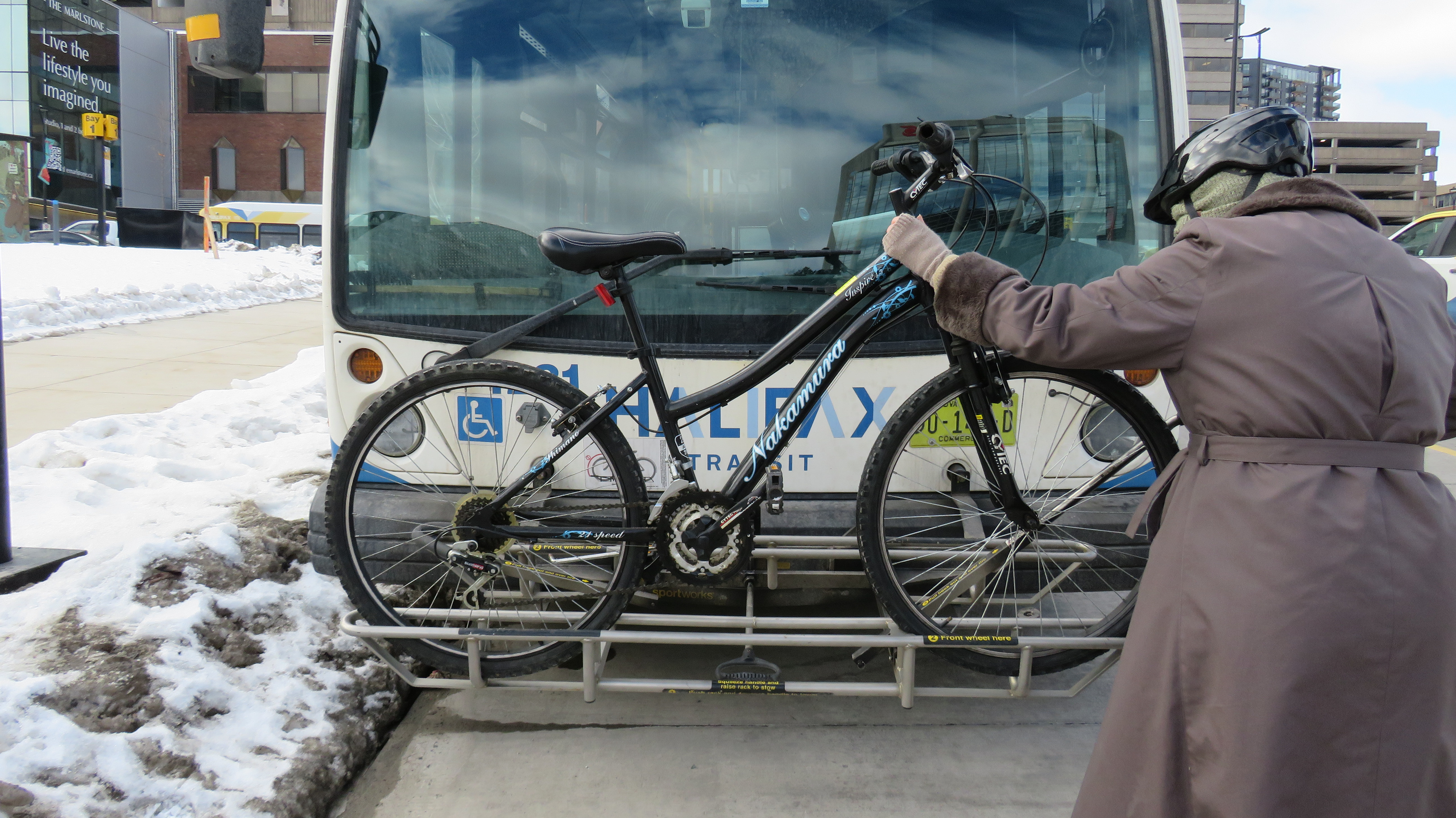 This is a reenactment of my first experience with the bike racks. I first used the bike racks before the start of the new year when I purchased a bike off of facebook marketplace out in Timberlea. Even though I had seen how the bike racks worked at Lacewood, I was still anxious for my first time on a real bus. The cold served as an extra barrier as my hands were numb. The experience  had me wishing I had a cheat sheet I could look at while I waited for the bus.