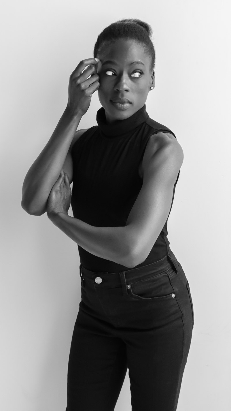 Ikeji Uju: Victoria Opemi stylishly dressed in all black with a top, jeans, and high heels. in San Francisco at a photography studio. Shot in Black and White. Ikeji Uju Photography