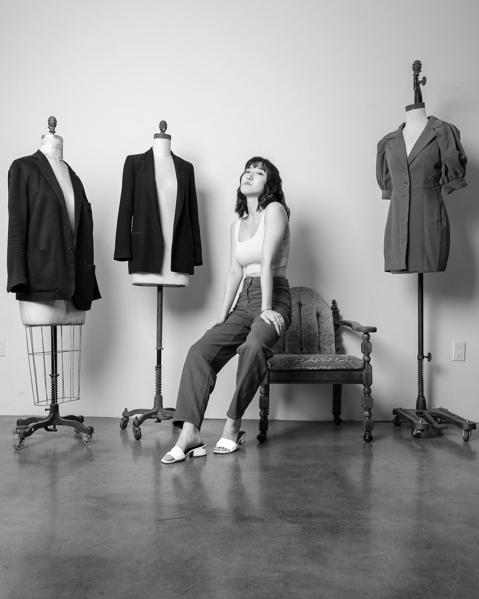 Ikeji Uju : Rae Wang's stunning elegance in a white top white slides and blue jeans on a vintage chair. Shot in Black and White. Ikeji Uju Photography