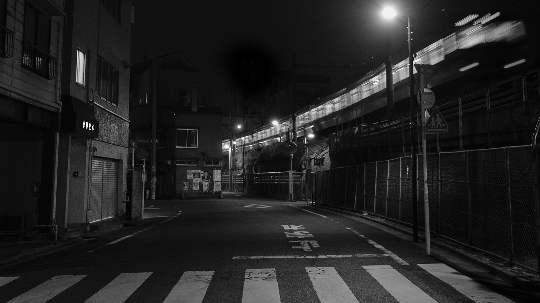 Captured by Ikeji Uju: The JR East Joban Line seen streaking by at night in Taito City, Tokyo, Japan. Shot in Black and White.