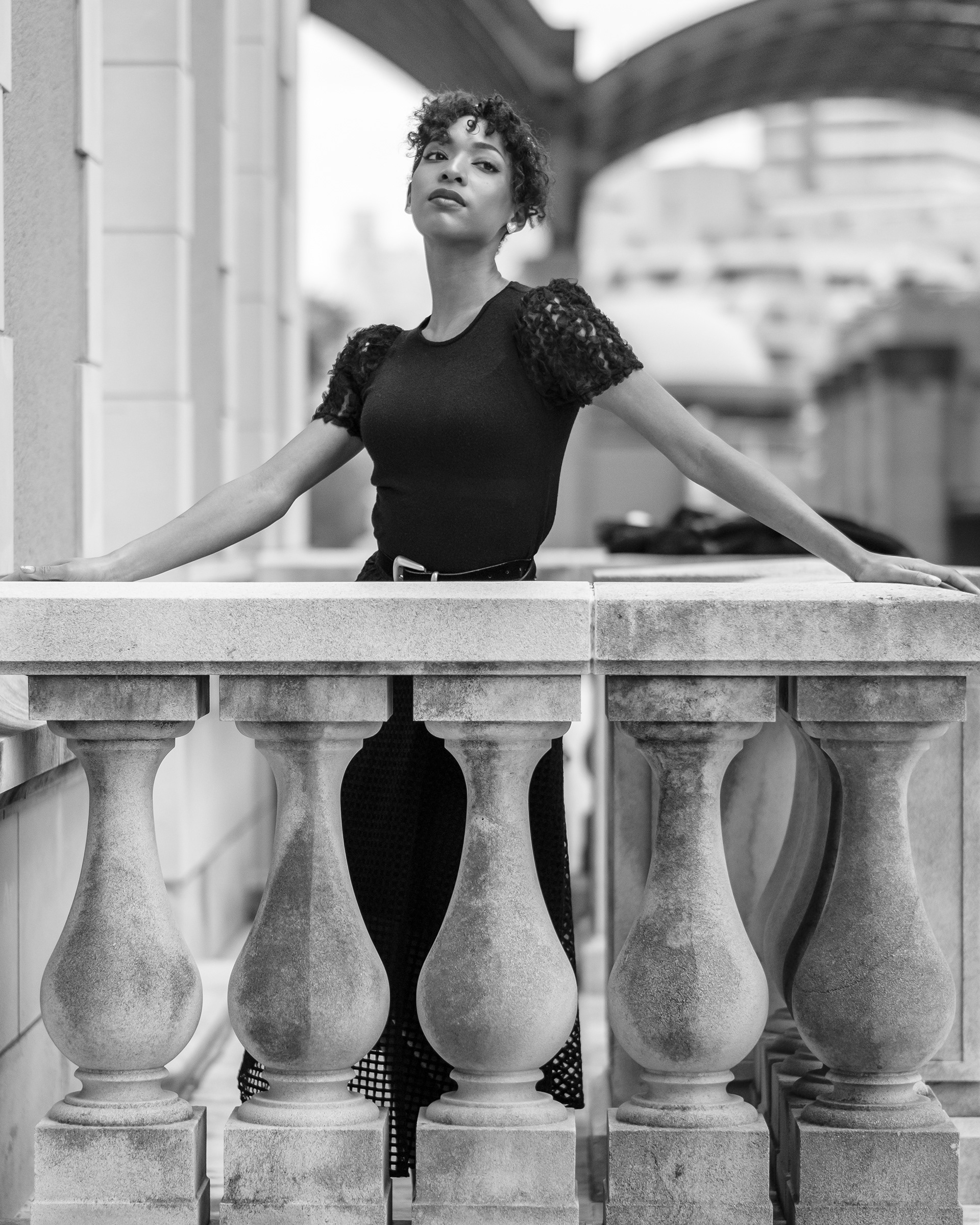 Ikeji Uju: Raimu Kaminashi elegantly dressed in an all black ensemble, set against the backdrop of Meguro City, Tokyo, Japan. Shot in Black and White. Ikeji Uju Photography