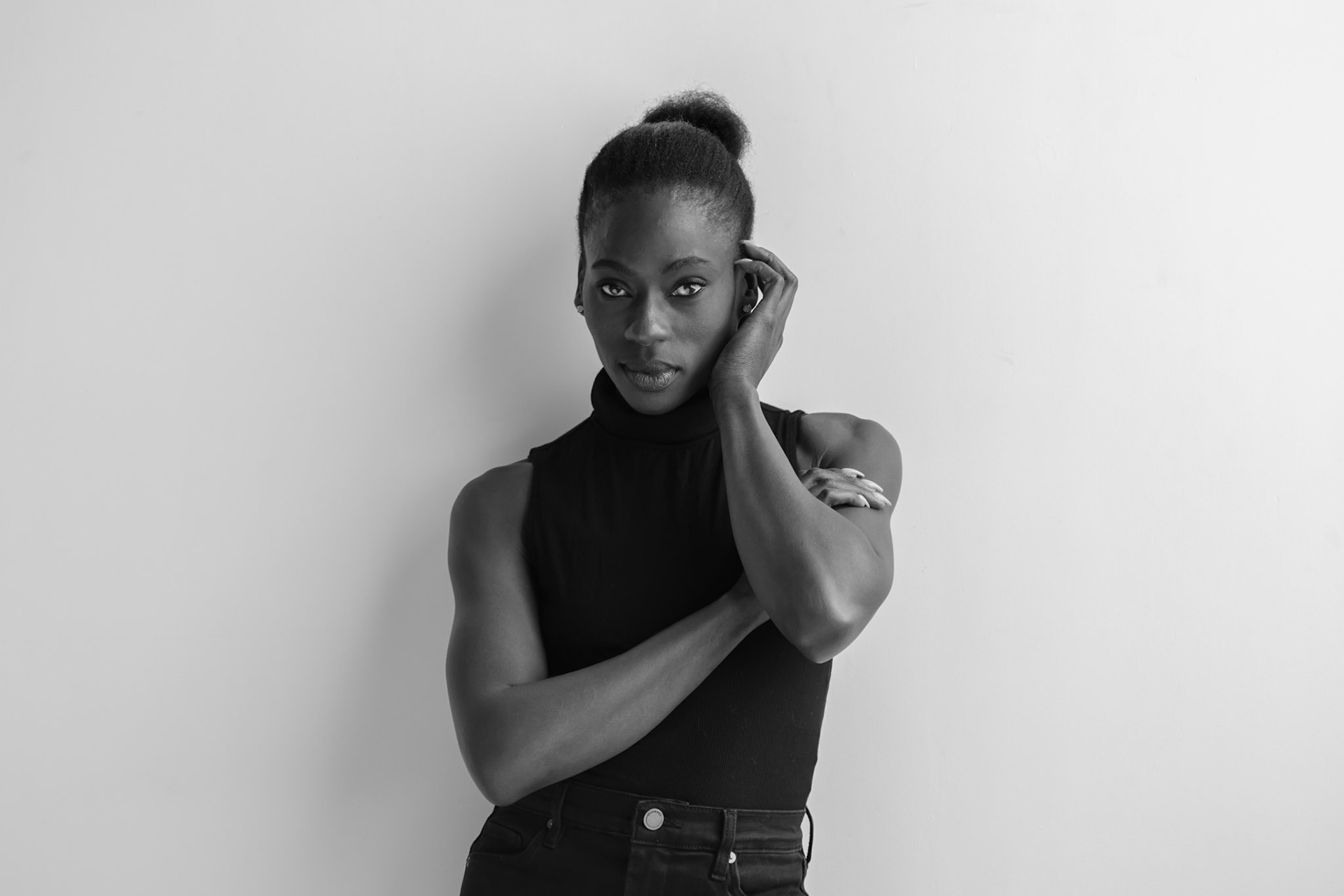 Ikeji Uju: Victoria Opemi stylishly dressed in all black with a top, jeans, and high heels. in San Francisco at a photography studio. Shot in Black and White. Ikeji Uju Photography