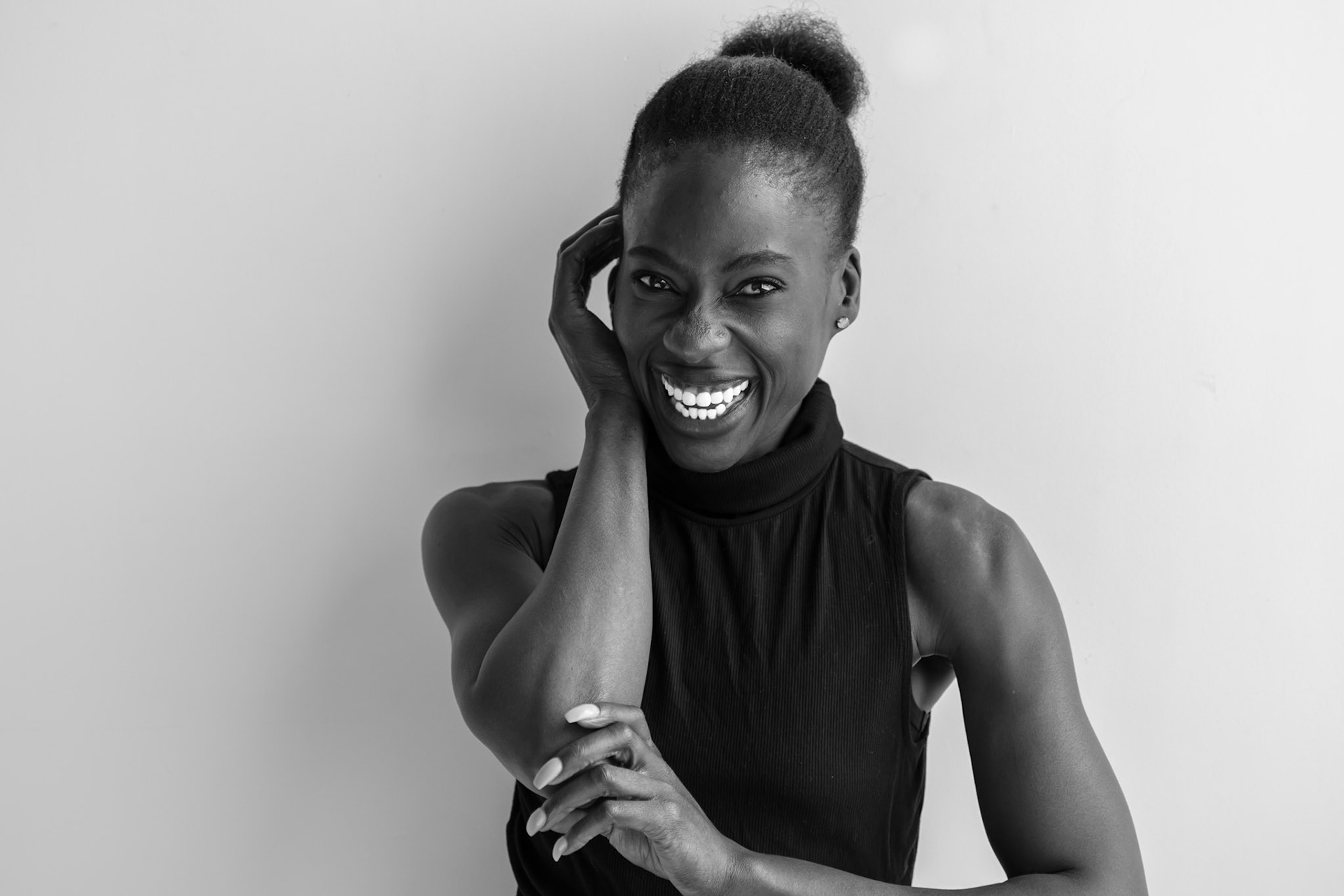 Ikeji Uju: Victoria Opemi stylishly dressed in all black with a top, jeans, and high heels. in San Francisco at a photography studio. Shot in Black and White. Ikeji Uju Photography