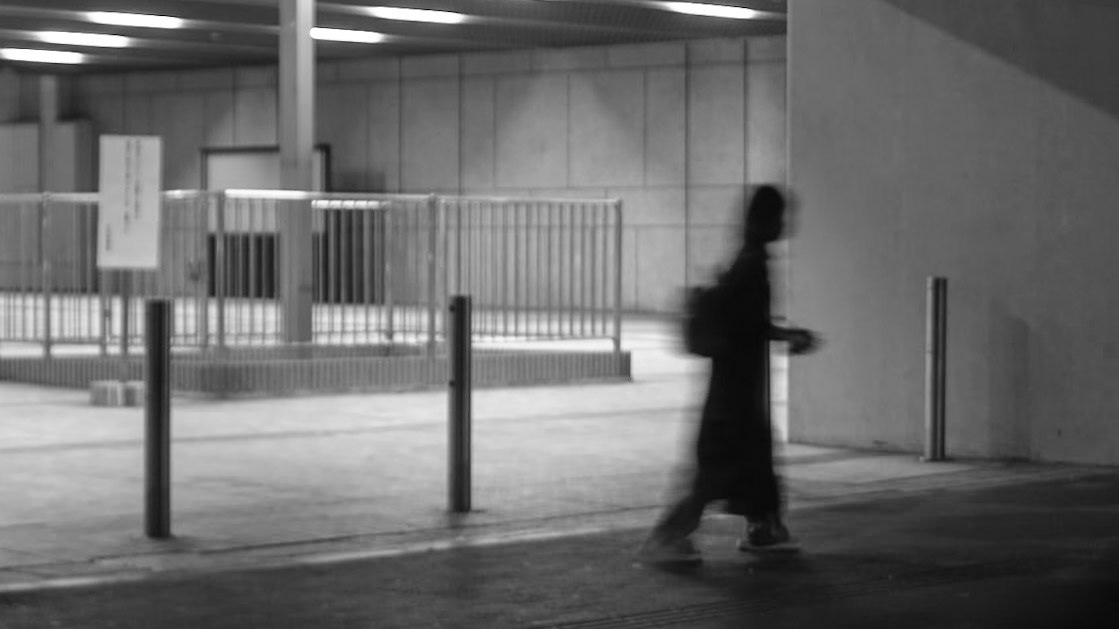 Captured by Ikeji Uju: A person walking around the Tokyo Metropolitan Government Building in Tokyo, Japan.