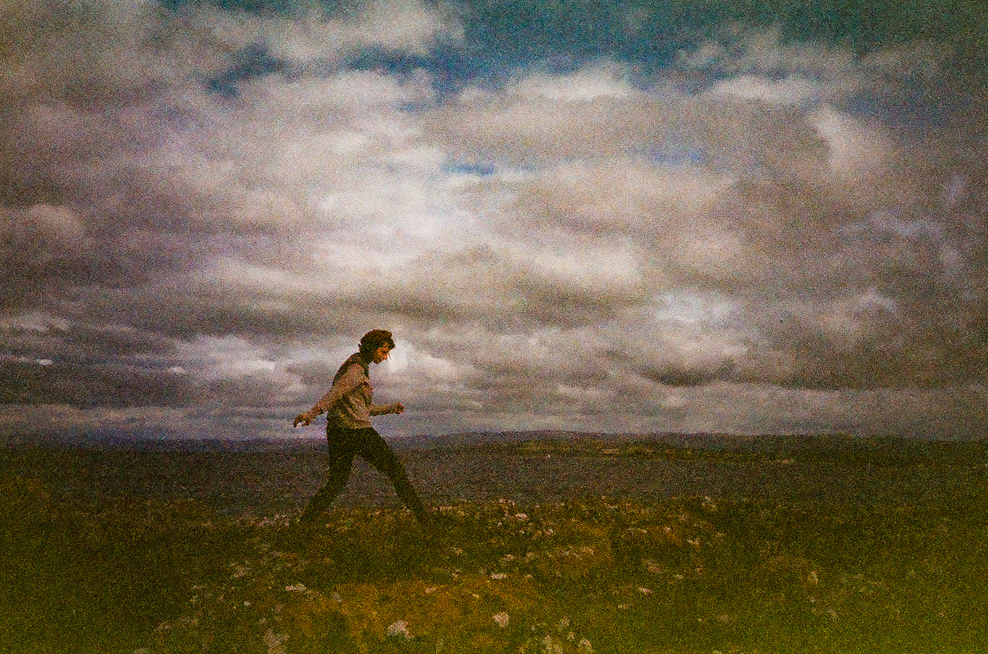 Oona walking across an open plain in the Isle of Bute. © Inigo Blake