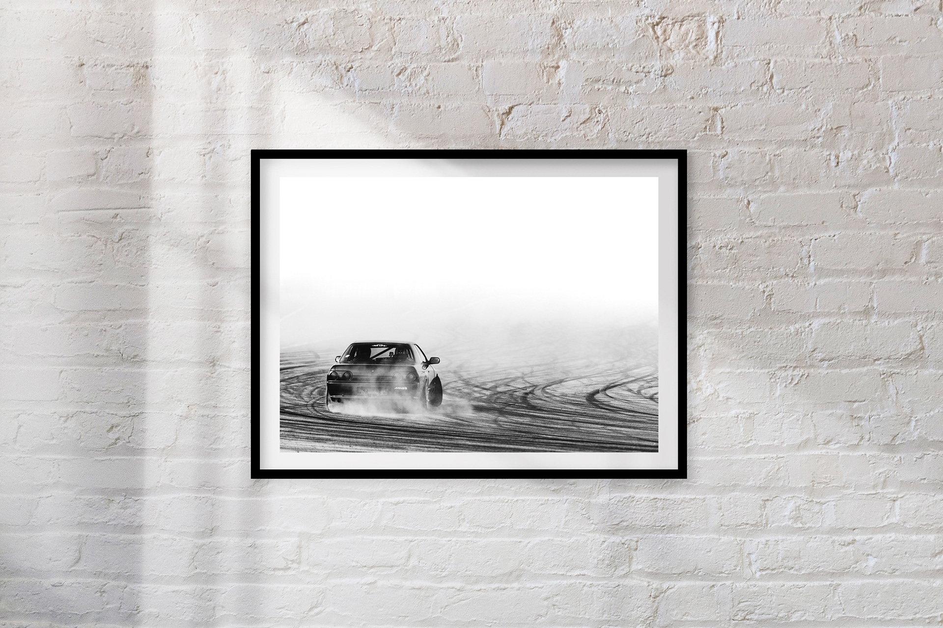 SLIDE: A Nissan Skyline R32 ignites its rear tyres and disappears into a fog of tyre smoke.