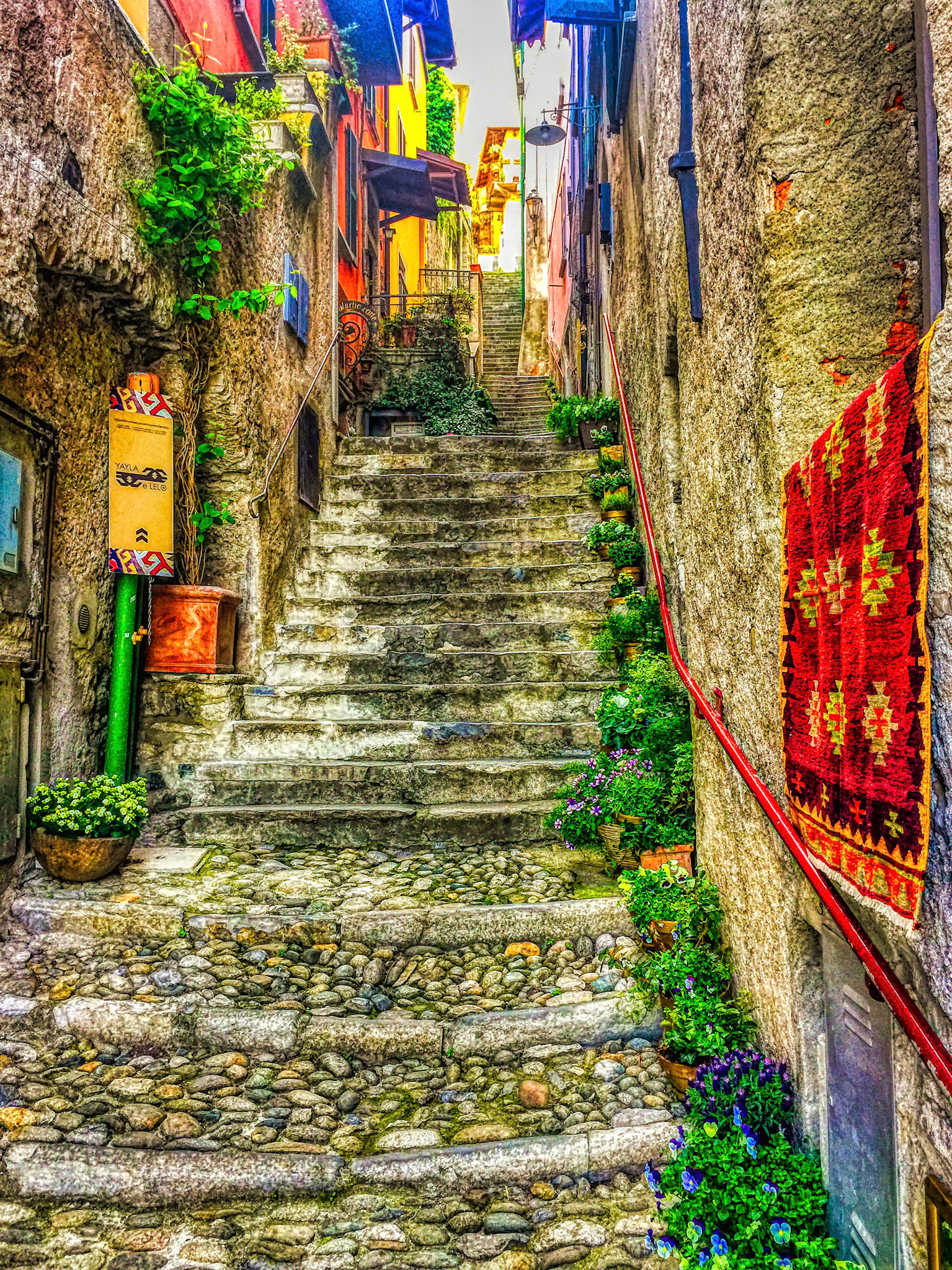 A beautiful stone stairway that was created by hand many many years ago, in Lake Como, Italy. At the base was a beach. At the top were restaurants and residential units.