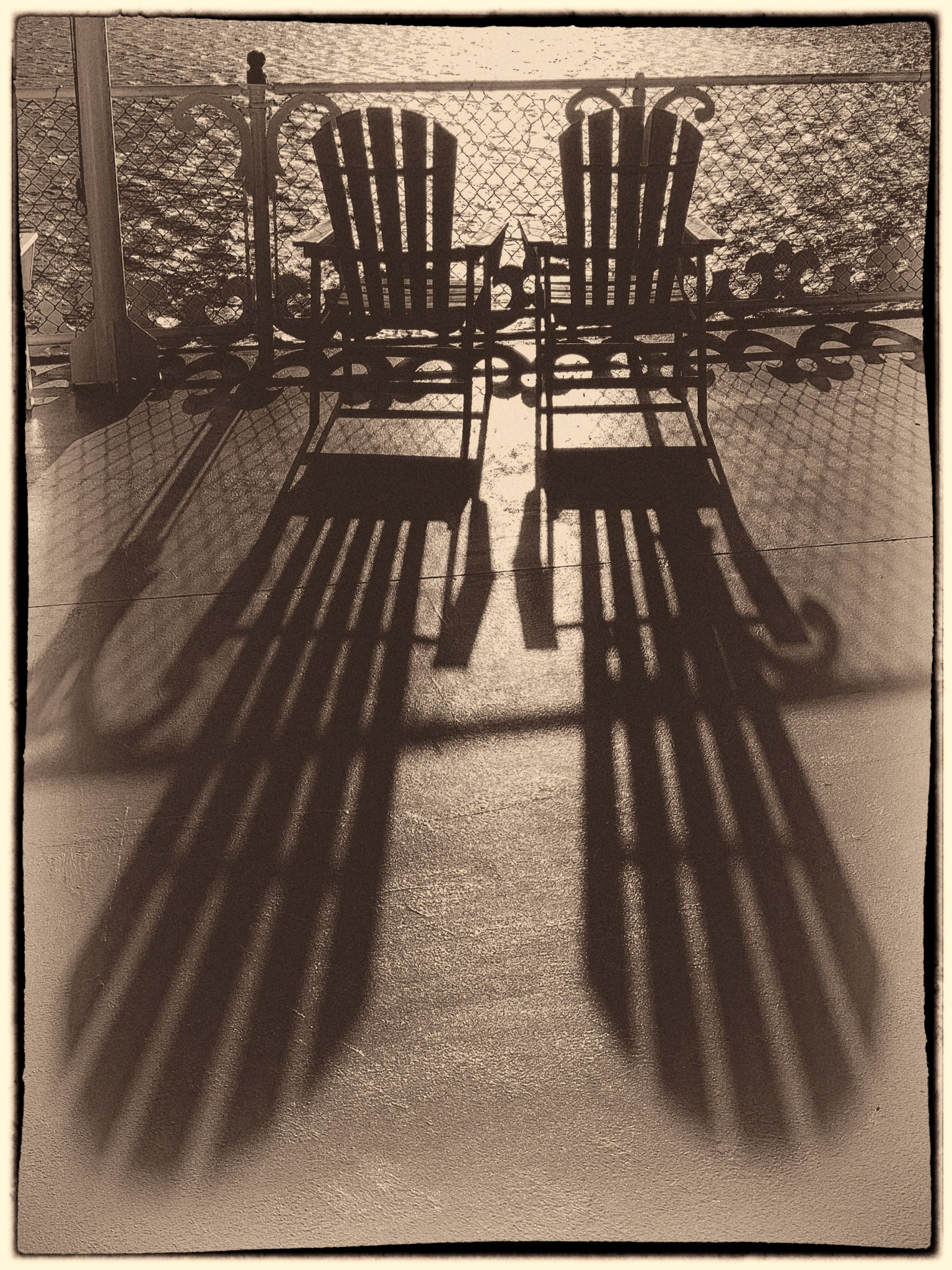 Two chairs in a nostalgic setting on the deck of a yacht somewhere on a lake near Barnson, Missouri