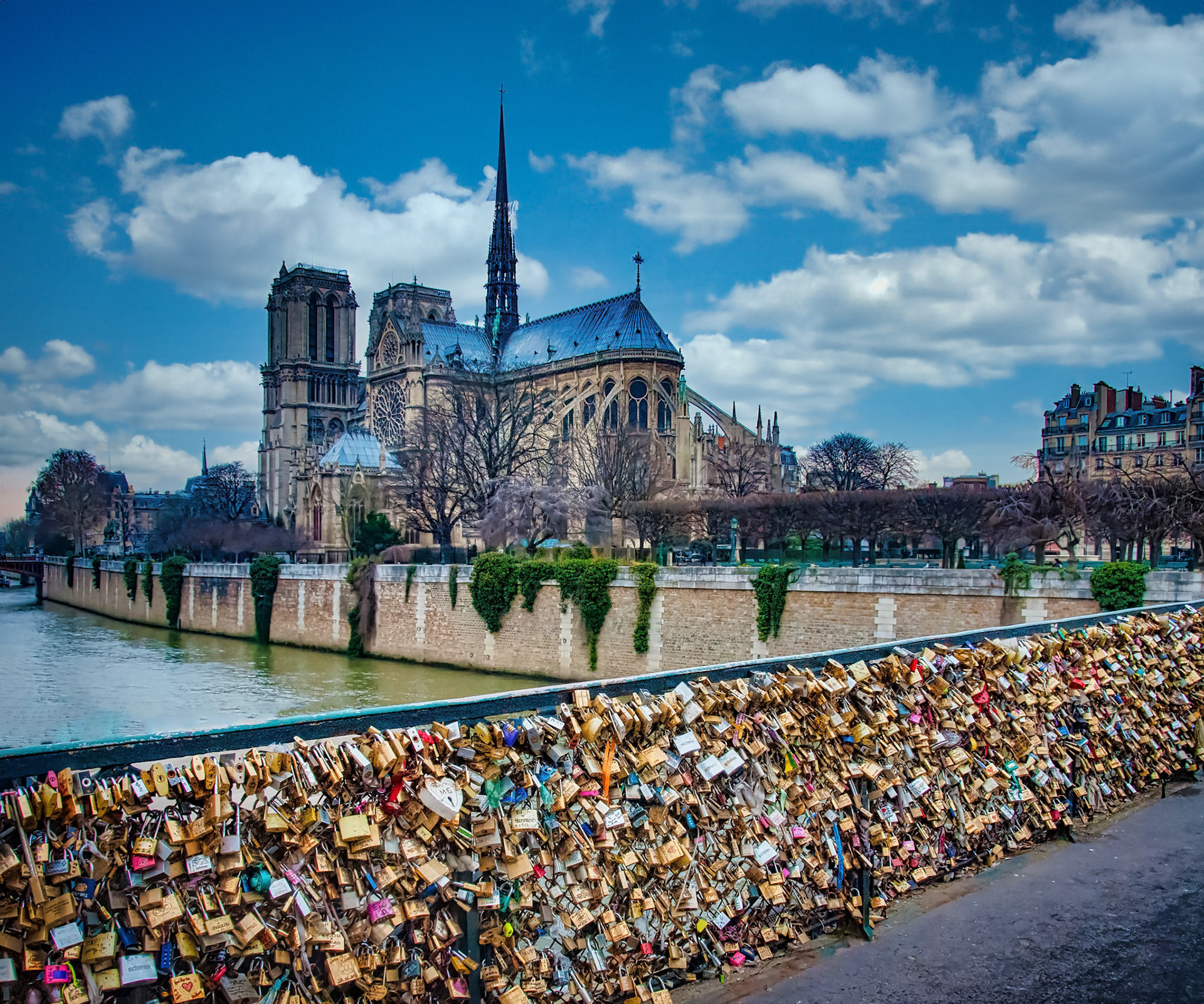 This is a picture of the Love Locks Bridge (actually the Pont des Arts bridge) from 2012. This is where lovers could write their names on a padlock, attach it to the bridge (or to other locks due to there being so many) and toss the key in the River Seine. Unfortunately, in 2015 a major portion of the bridge collapsed into the river. From then on doing this became illegal in Paris.That is the famed Notre Dame Cathedral in the background. As you may know a fire caused heavy damage to it in 2019. Reconstruction is complete and the reopened cathedral is amazing.