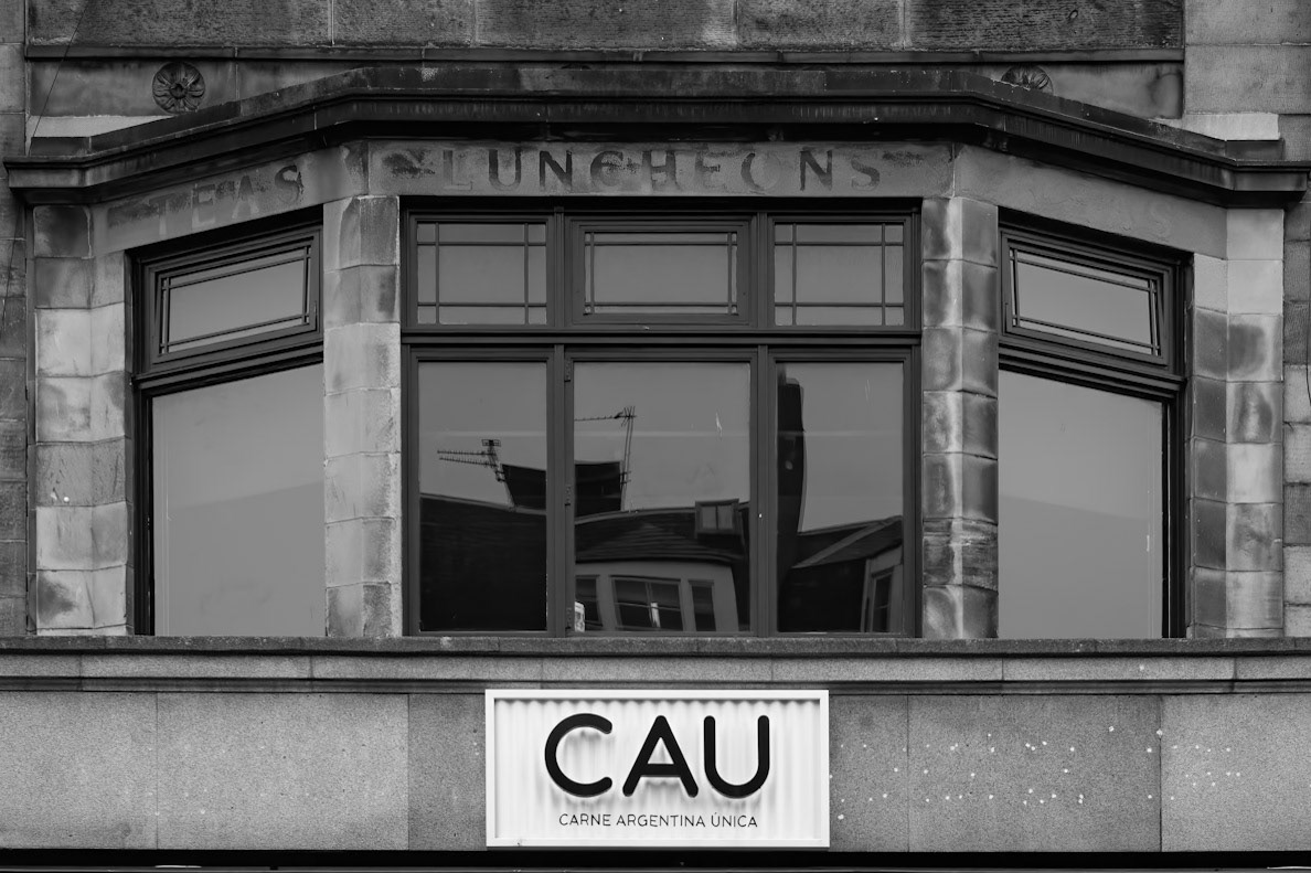 CAU shop sign below old Edinburgh tea room sign