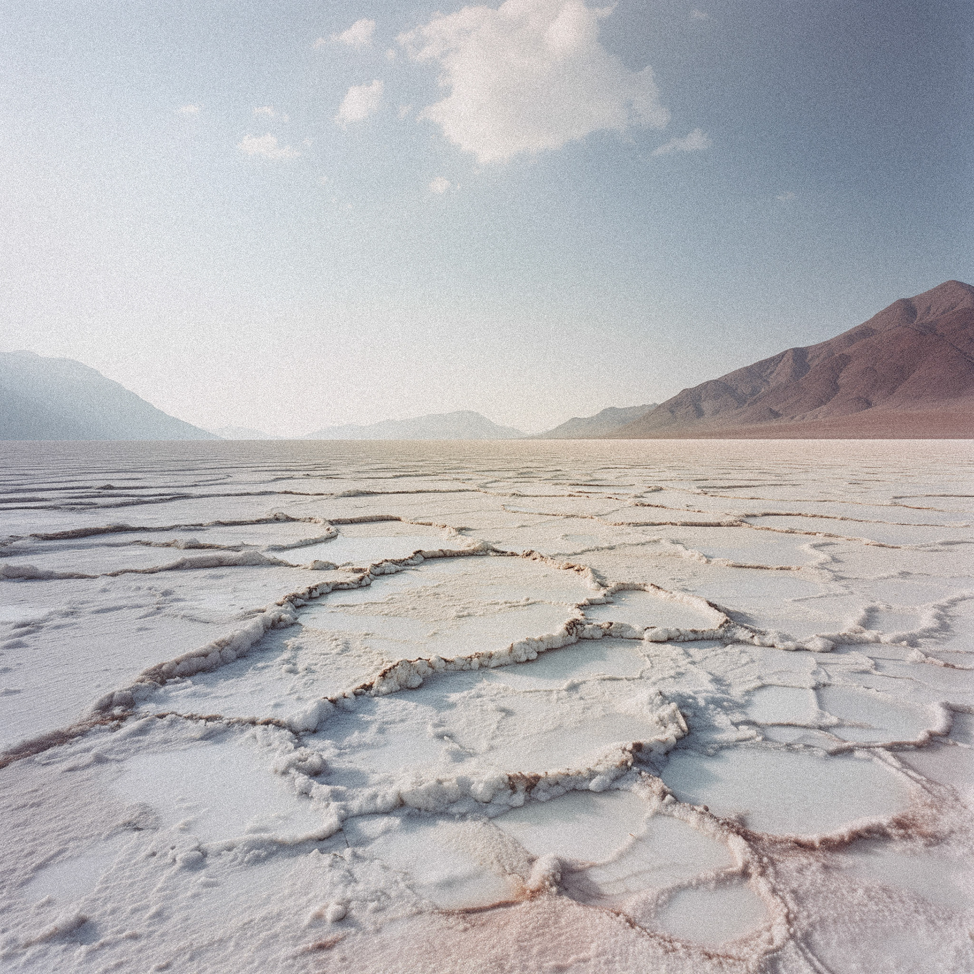 A breathtaking wide-angle shot of vast lithium fields in Peru, captured with a large format camera, emphasizing sharp details and incredible depth, styled to resemble the iconic, meticulously detailed aesthetic of Andreas Gursky. The composition should highlight the expansive, almost abstract nature of the lithium fields, with layers of textures and patterns created by the salt flats and minerals, set against a stark horizon and a clear sky. The colors should be natural, muted yet vibrant, capturing the essence of the landscape in high resolution ‚Äìar 16:9 ‚Äìquality 2 ‚Äìstylize 750 ‚Äìstyle scenic ‚Äìchaos 10 ‚Äìseed 12345 ‚Äìstop 100 --v 6.1 Job ID: 37bb433d-fd93-4fb7-b318-45a5cfa1d998