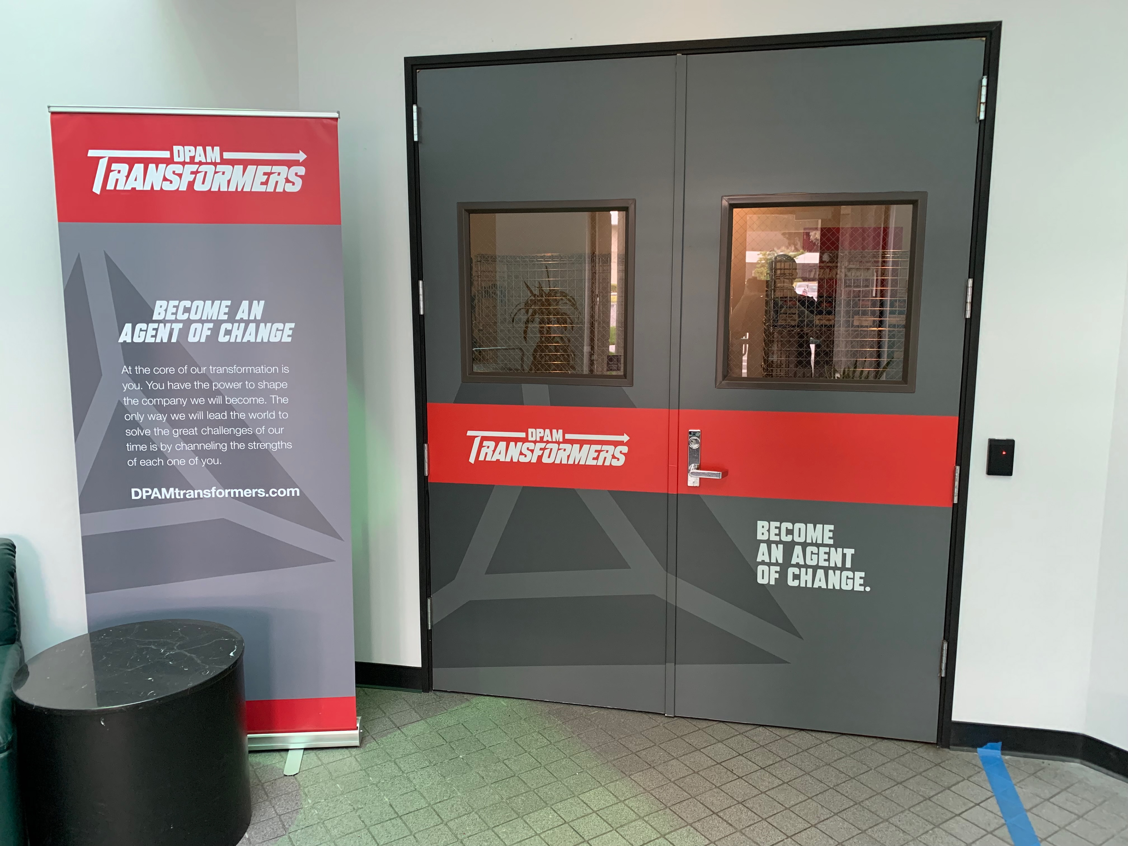 Vinyl door wraps and pop up displays greeting associates as they entered for work.