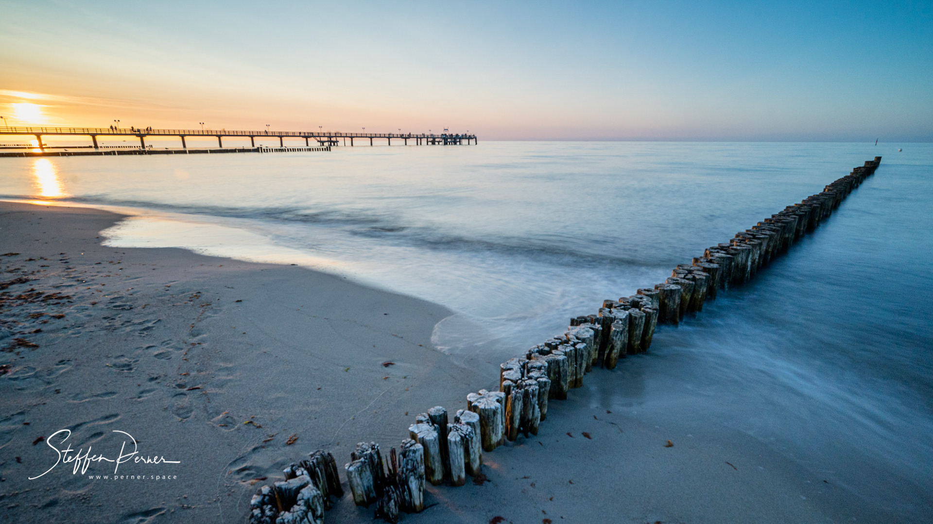 Sun set and groyne at baltic sea