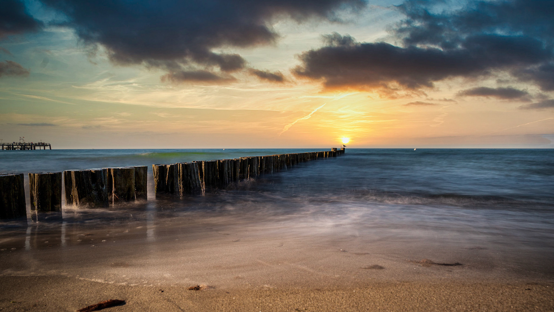 Sun set and groyne at baltic sea