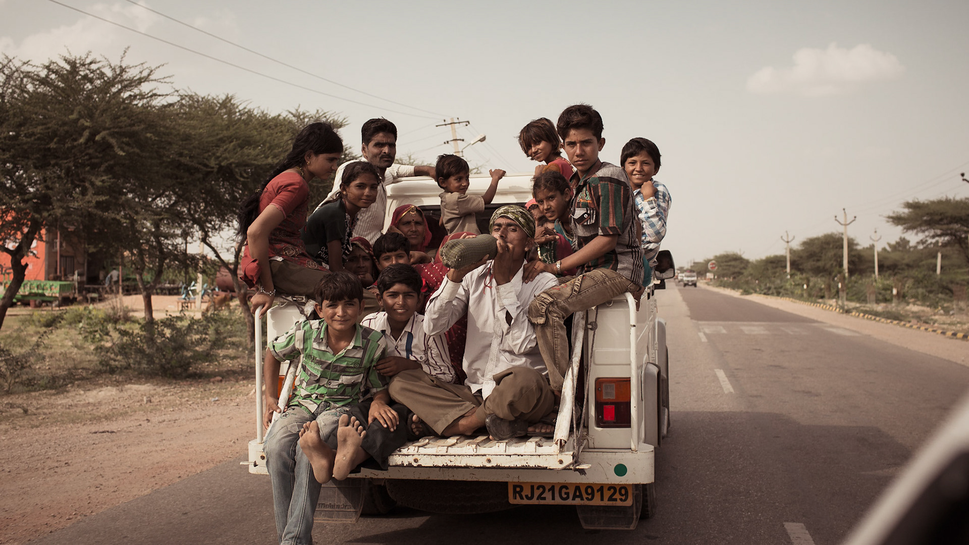 People travaling with a overloaded pickup van Rajasthan. Bikaner, India