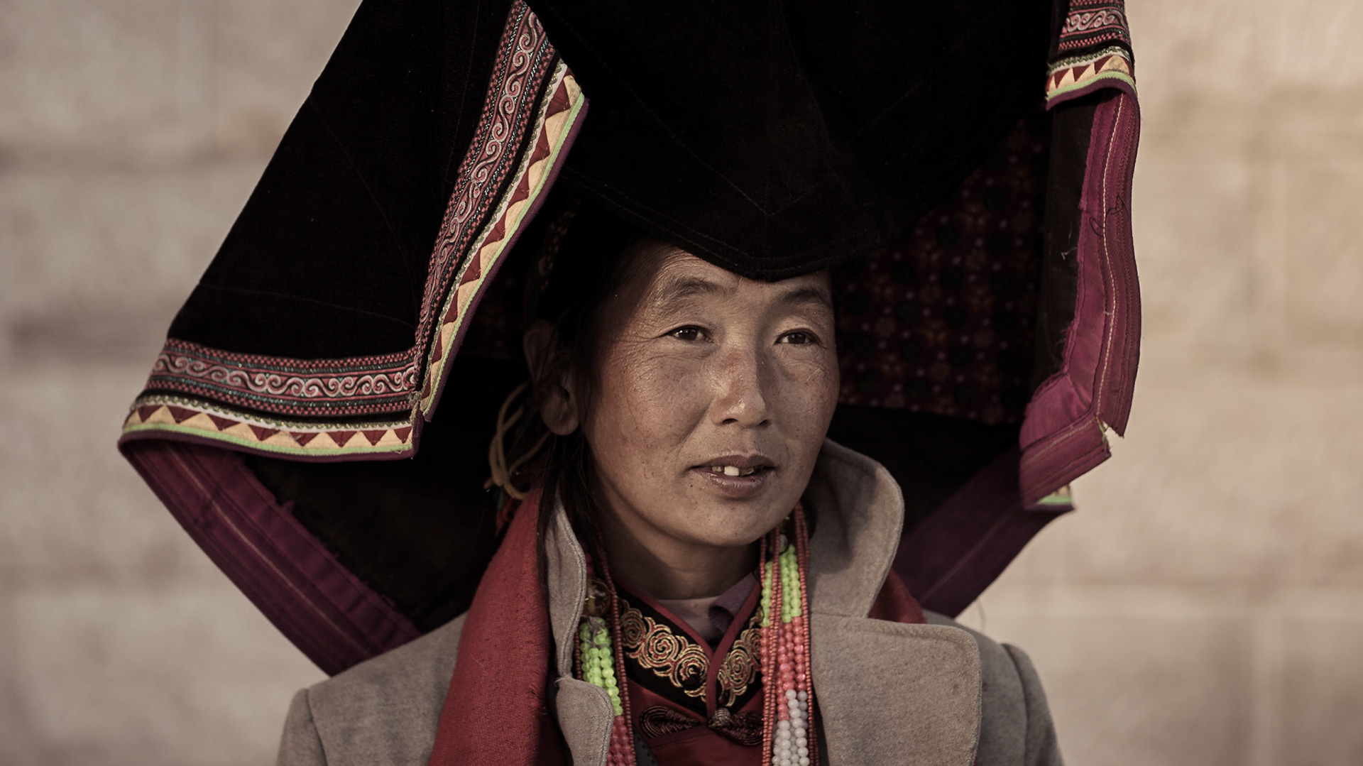 Portrait of Yi tribal woman in her traditional clothes. Yunnan Province, China