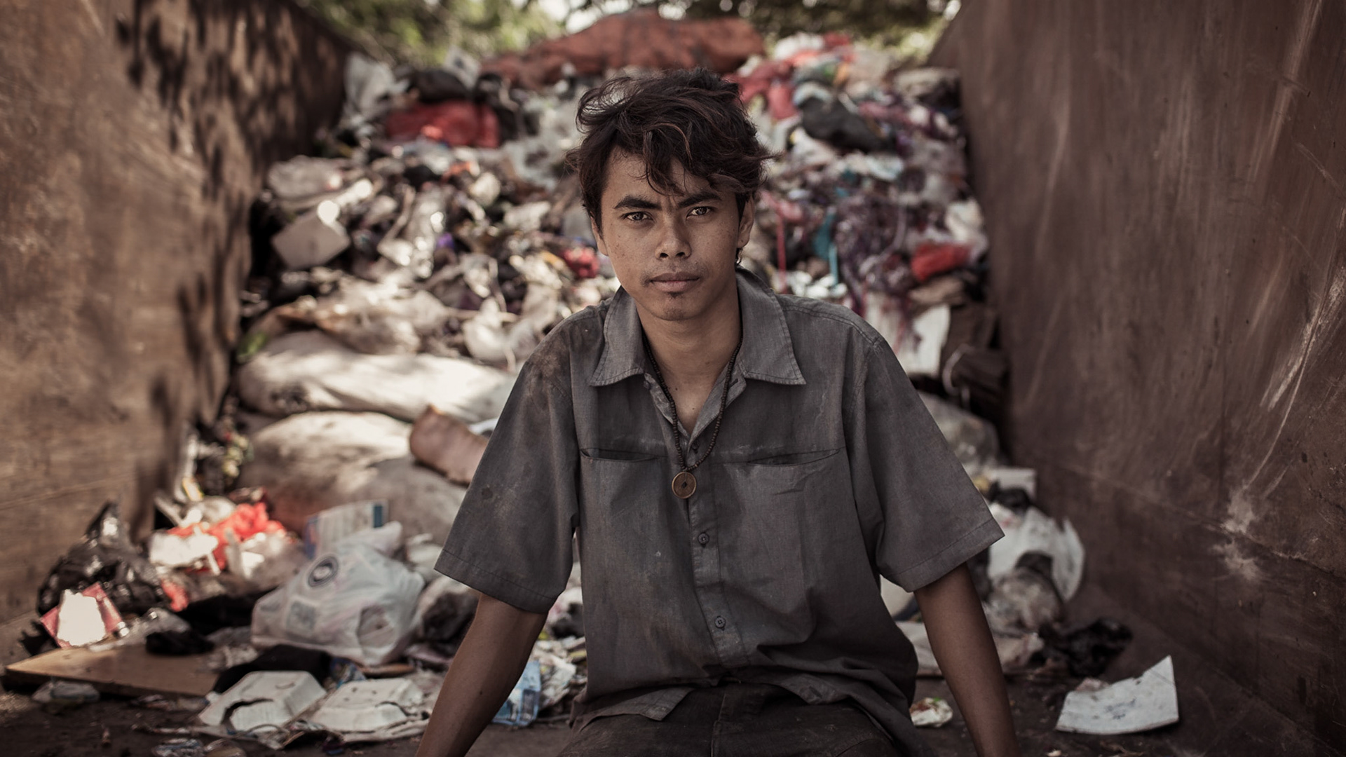 A young man collecting garbage to make ends meet. Jakarta, Indonesia