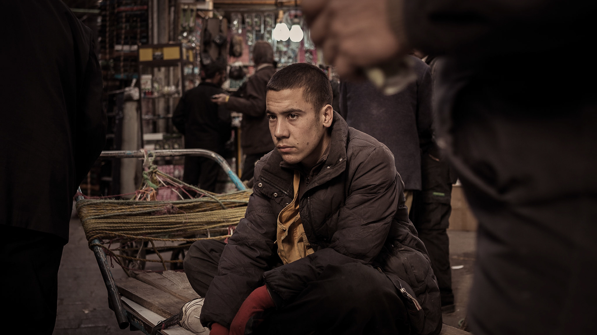 Lost in the moment while taking a break from cart hauling in the barzar. Tehran, Iran