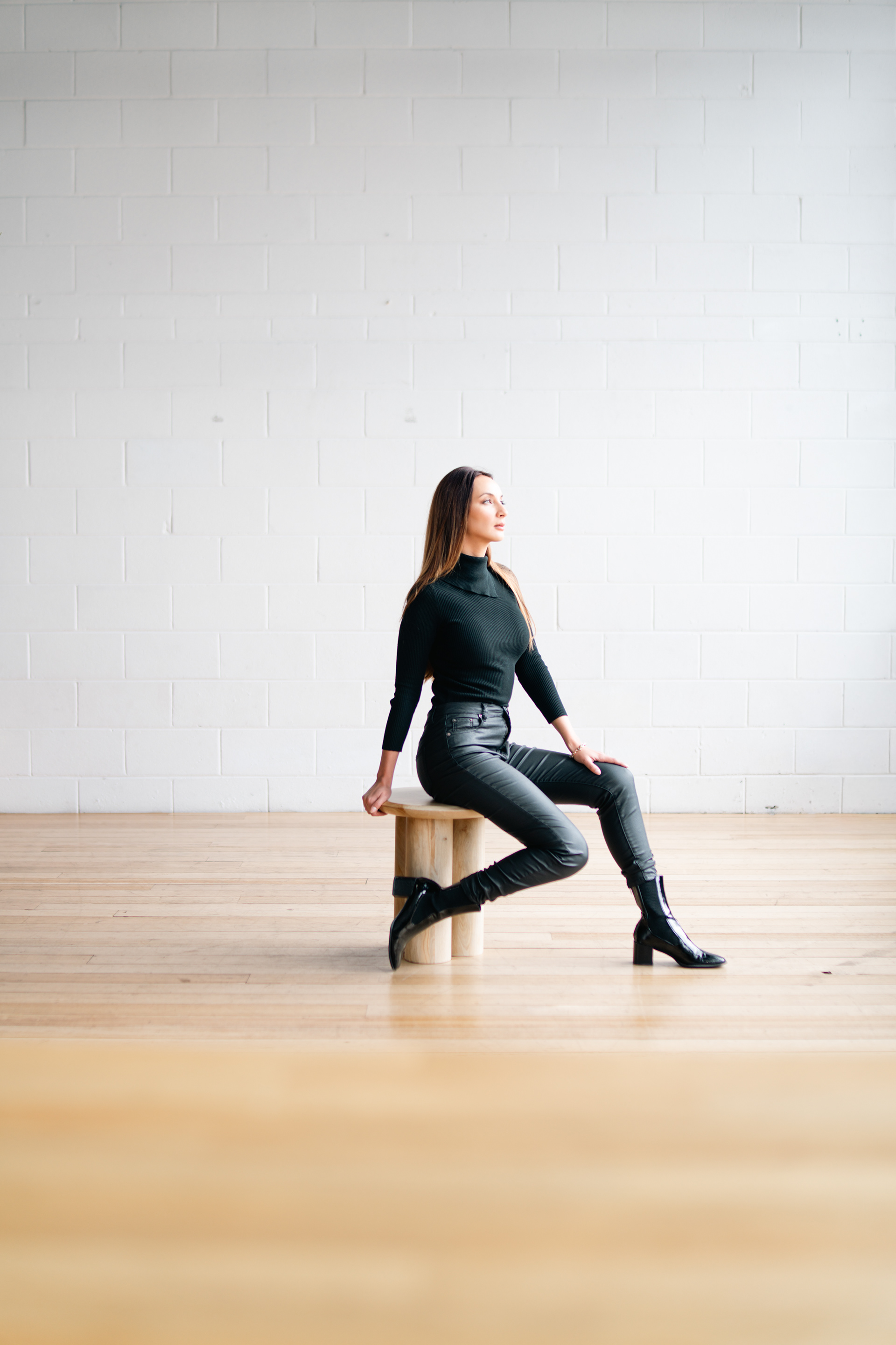 Seated fashion portrait in a bright studio