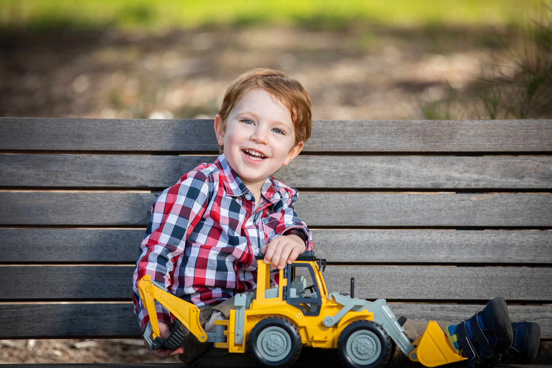 Child seated with a yellow bicycle