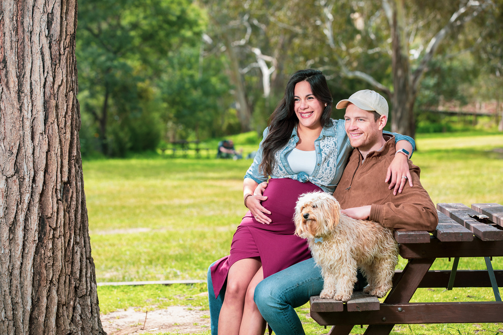 Family sitting together on a park bench