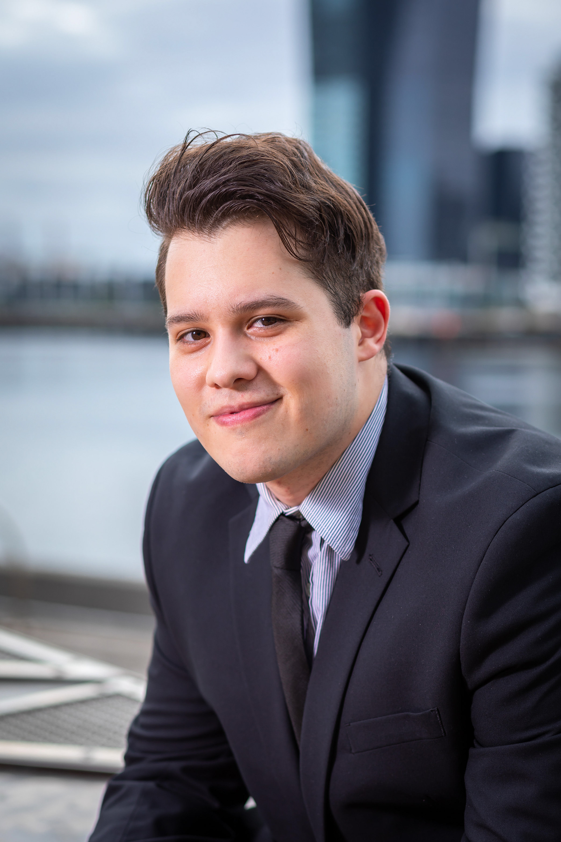 Close-up portrait in a blue shirt with an urban background