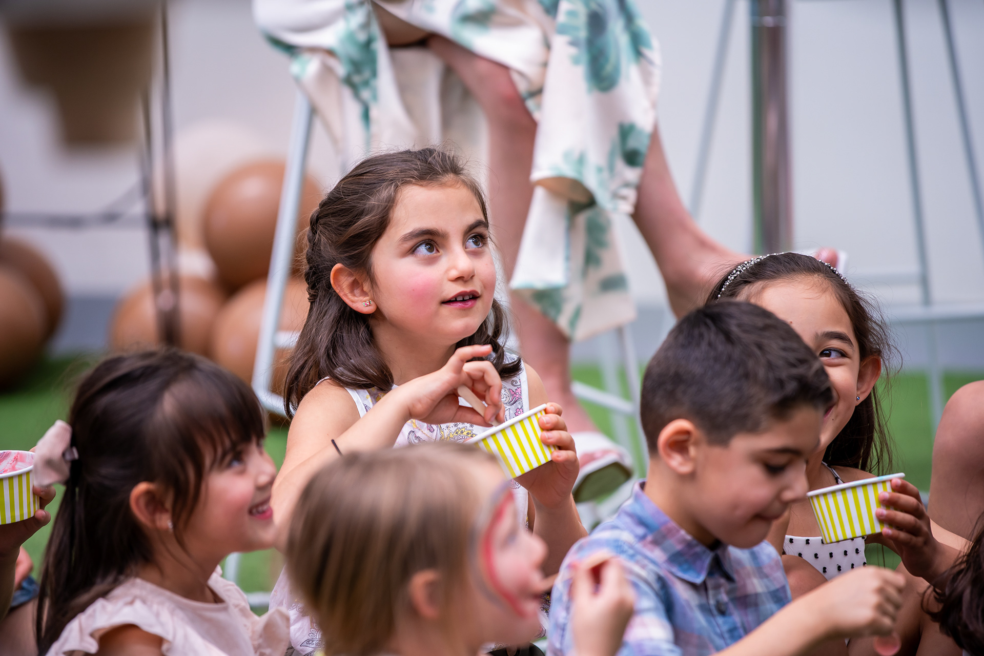 Children watching a performer at a party