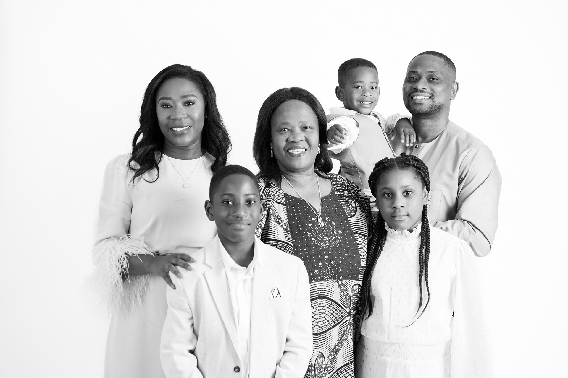 Black-and-white family group portrait against white