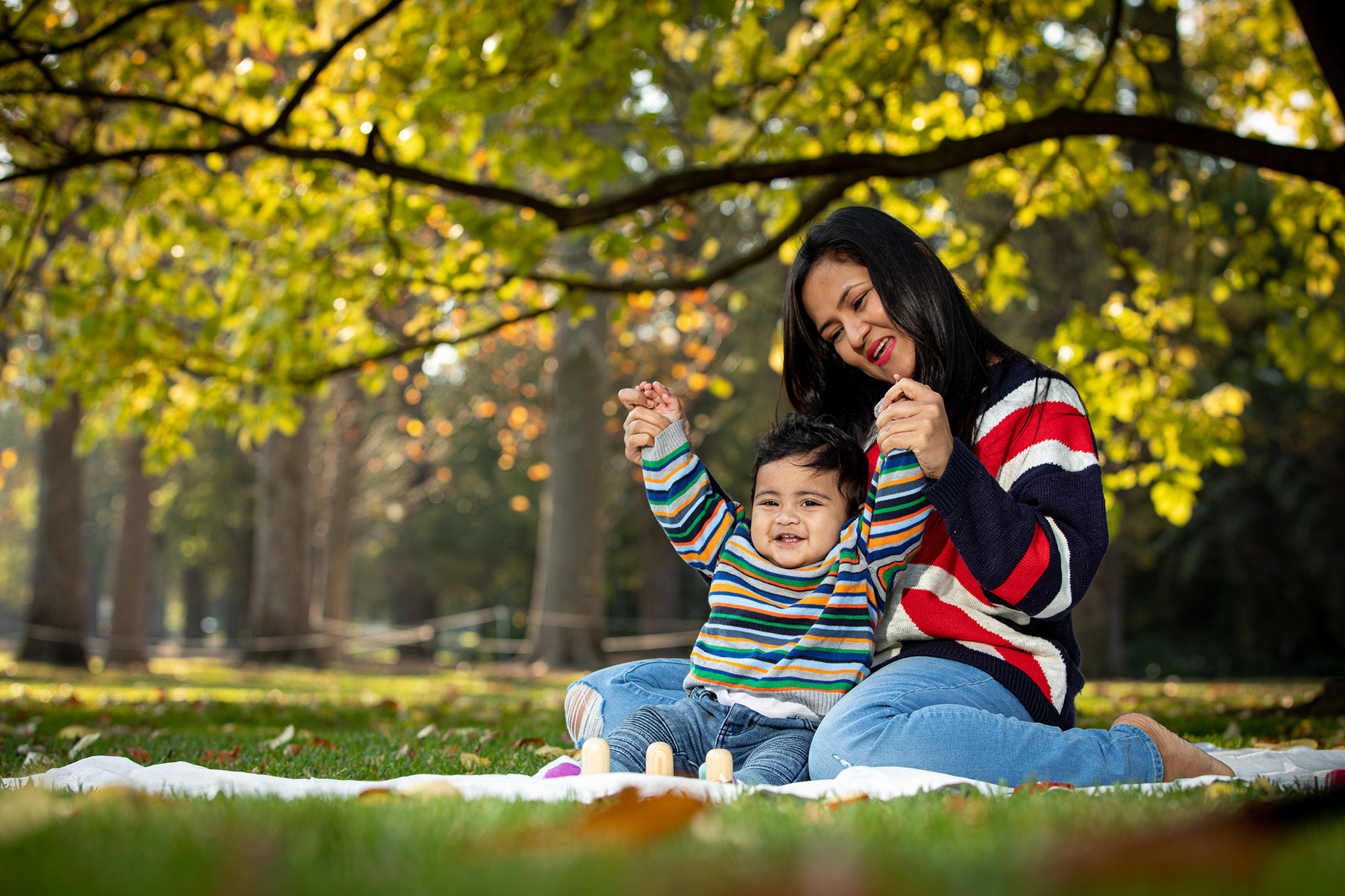 Parent and child sitting beneath a tree