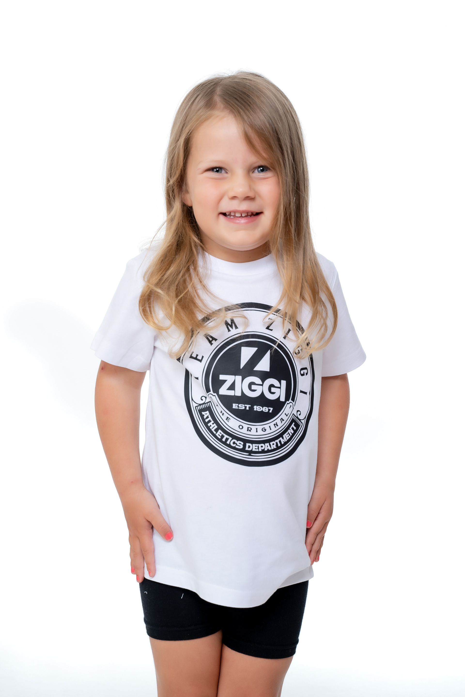 Child wearing a white sports T-shirt against white