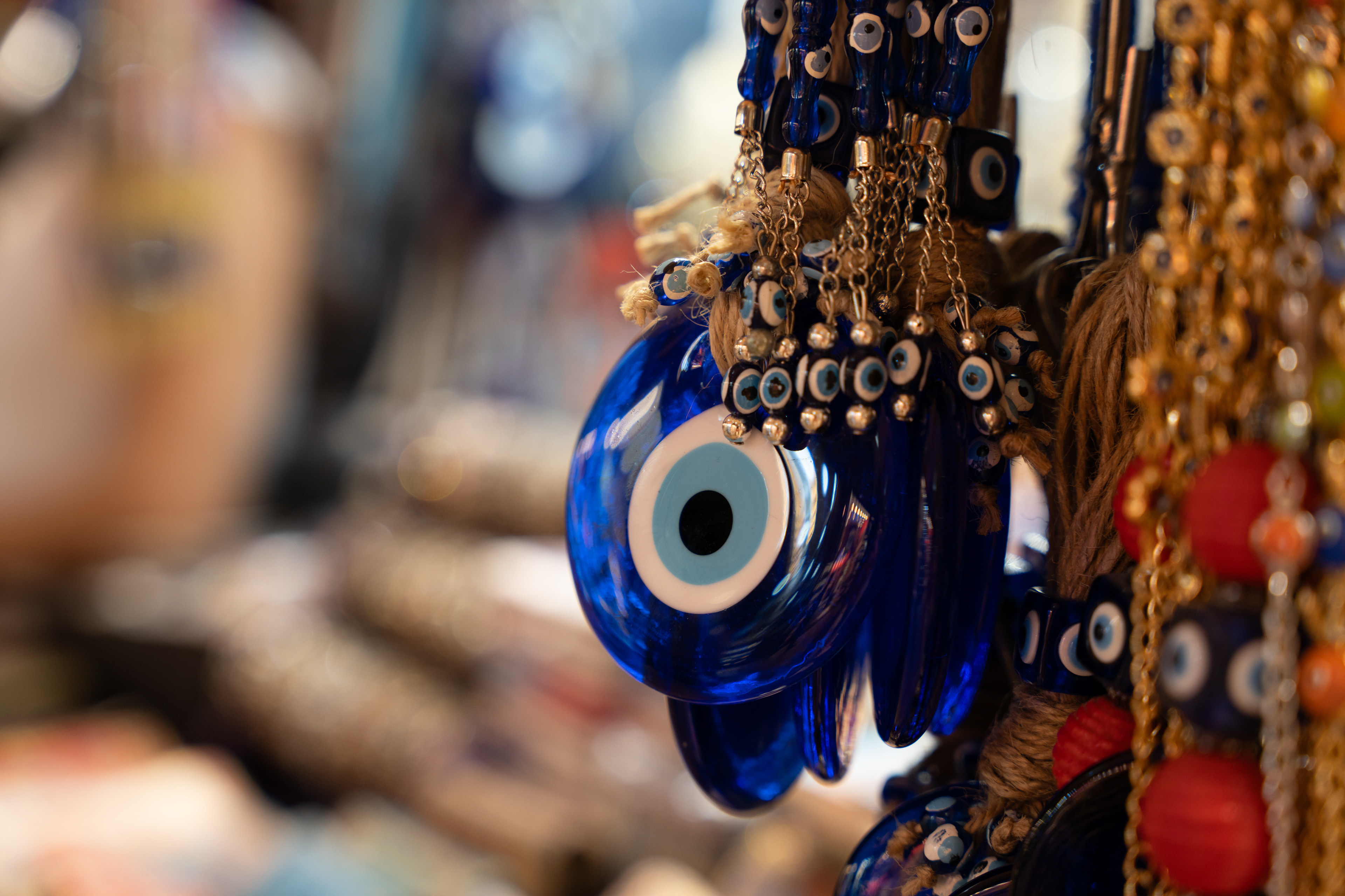 Blue glass evil-eye charms displayed at a market