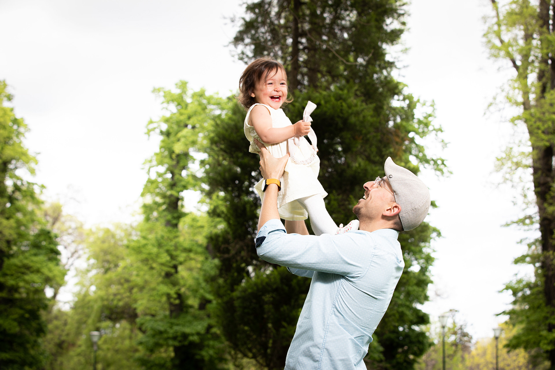 Parent holding two young children outdoors
