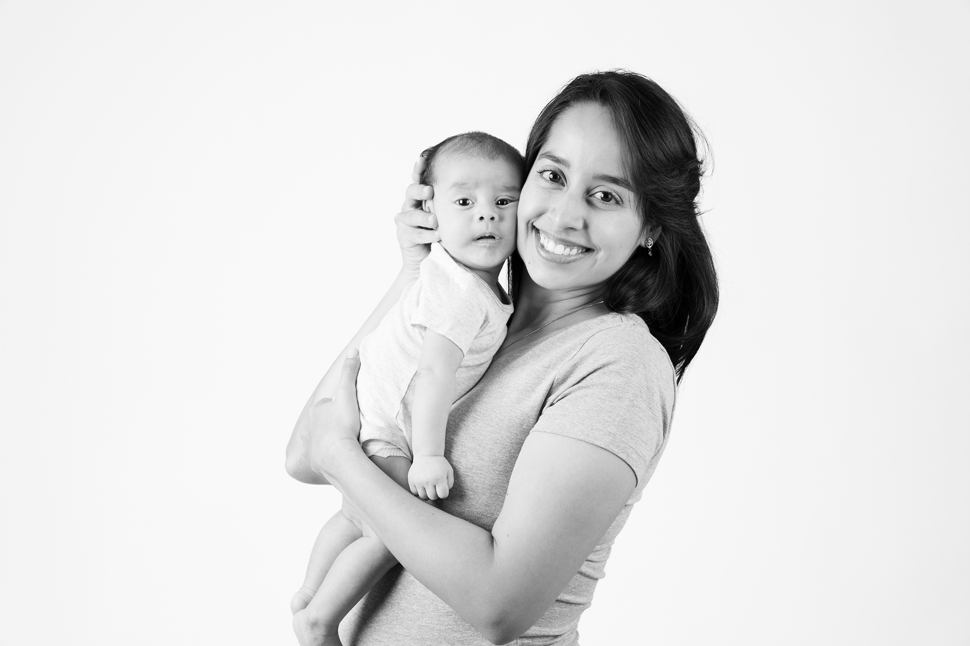 Black-and-white portrait of a parent holding a child