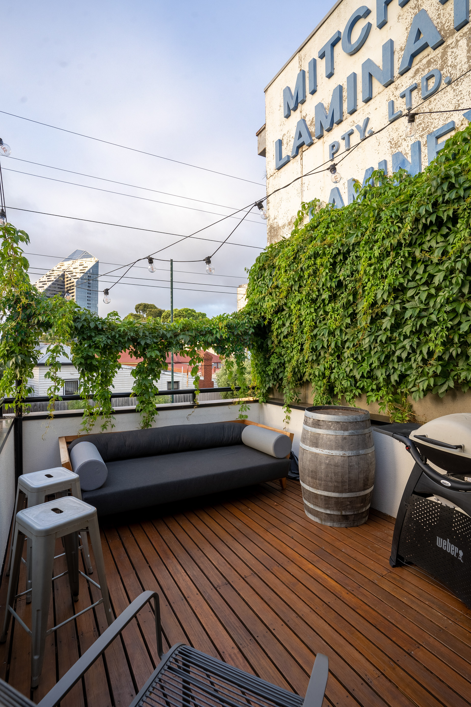 Outdoor terrace with climbing greenery and timber decking