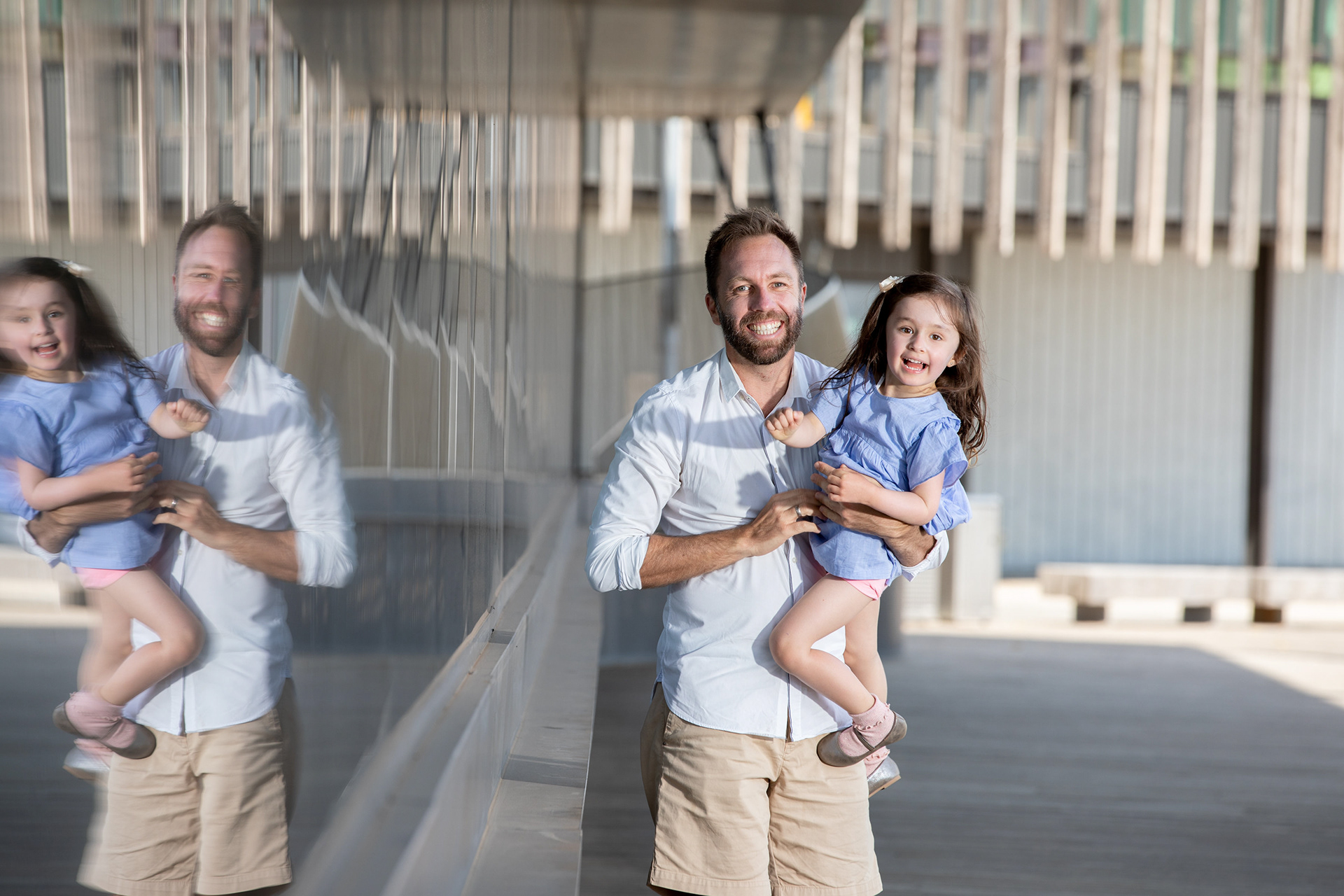 Family standing together outside a modern building