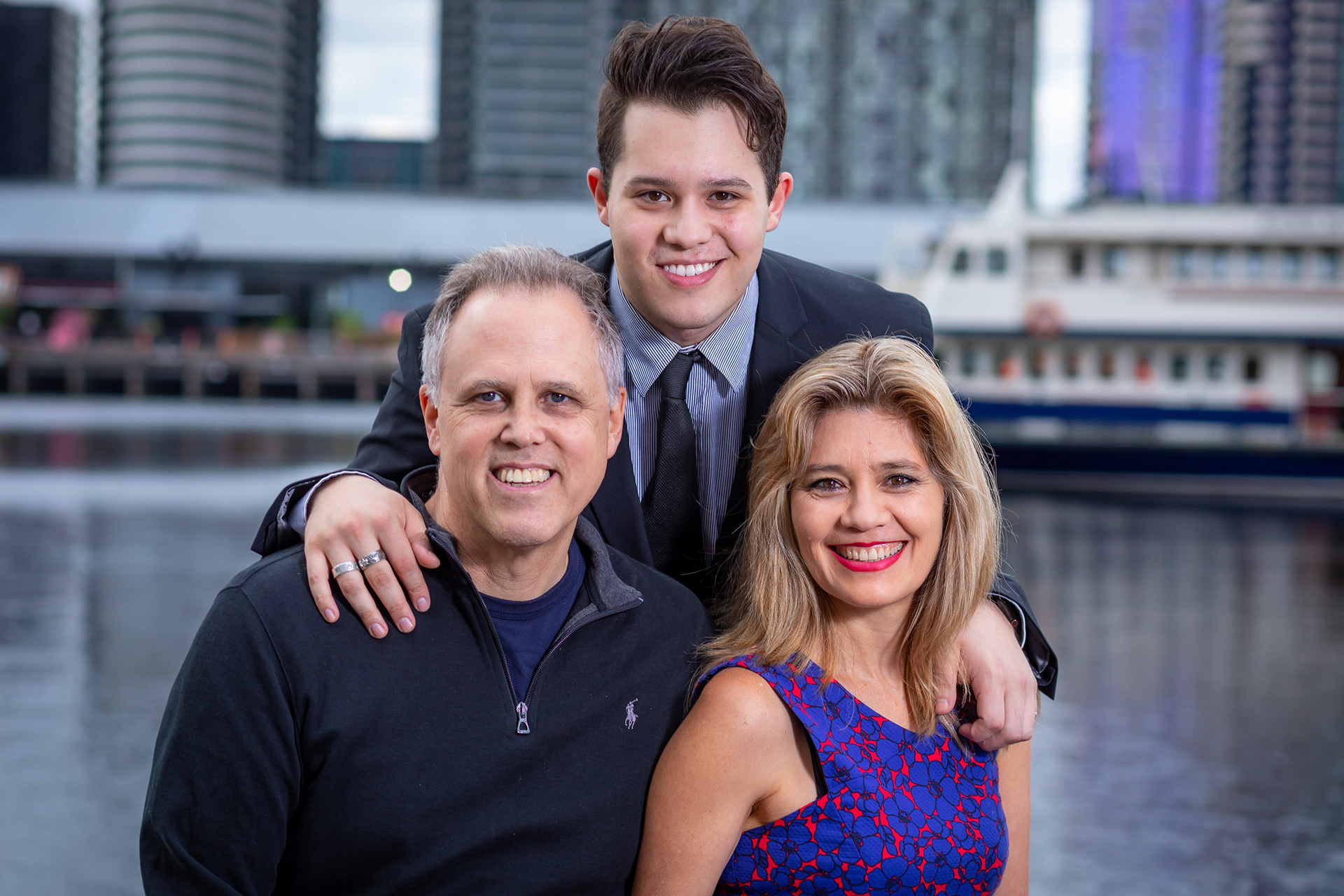 Parent and child smiling beside the waterfront