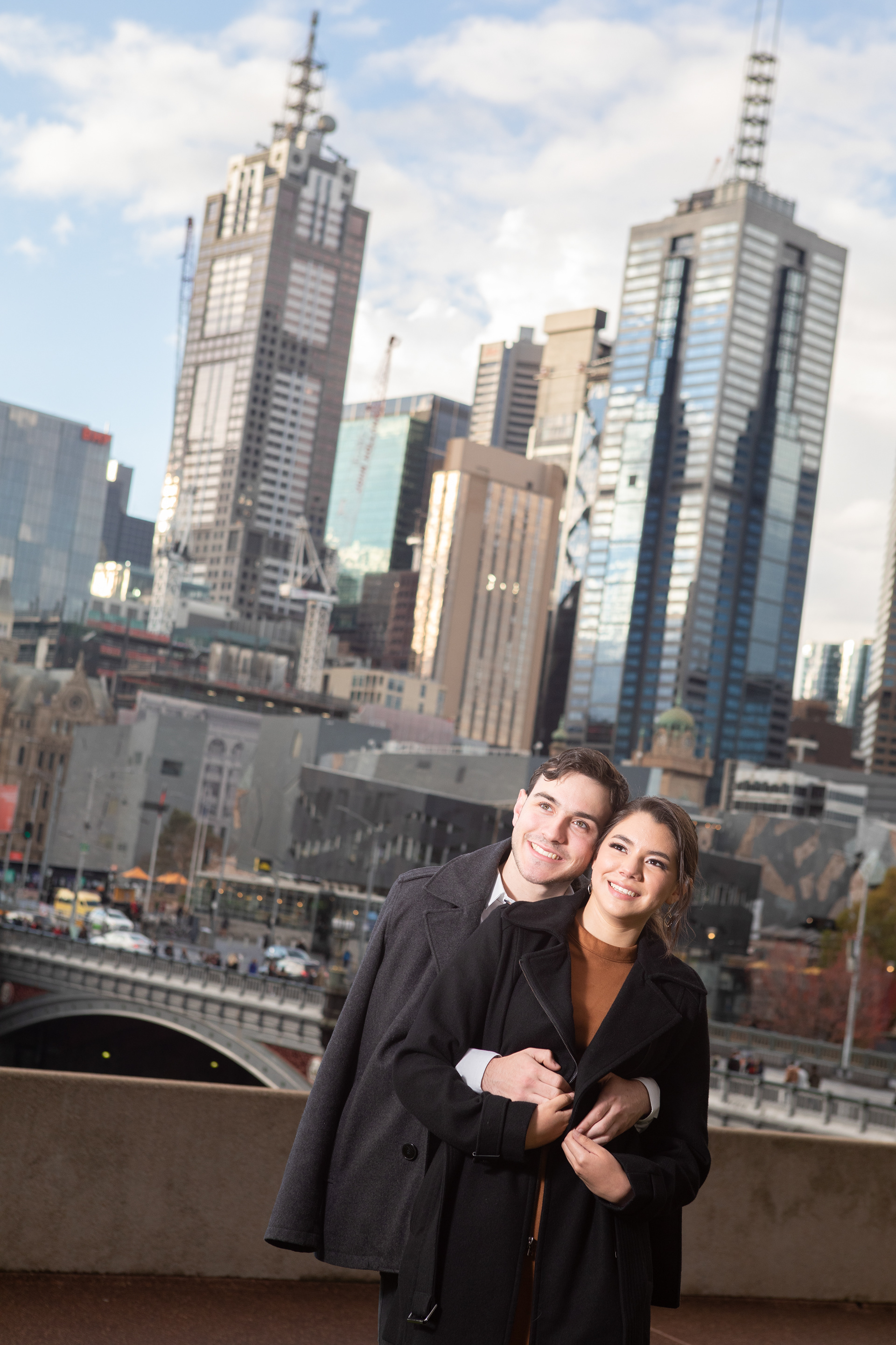 Couple looking out over the city from a balcony
