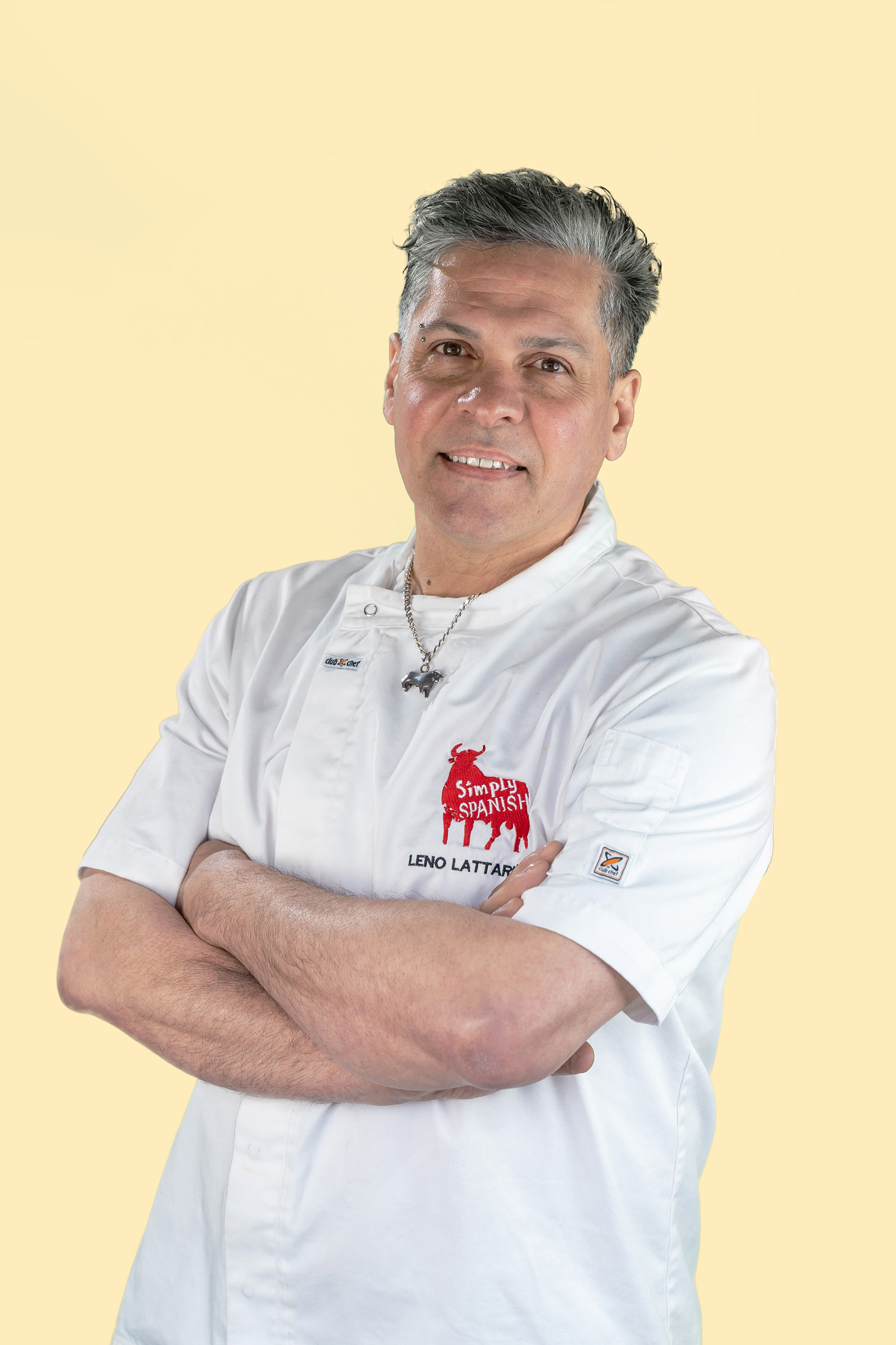 Portrait in a white polo shirt against a yellow background