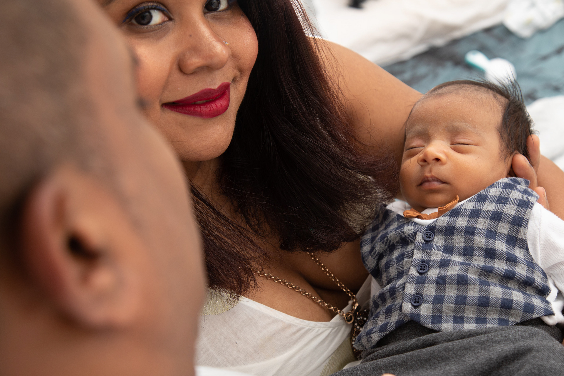 Close-up of a parent holding a sleeping baby
