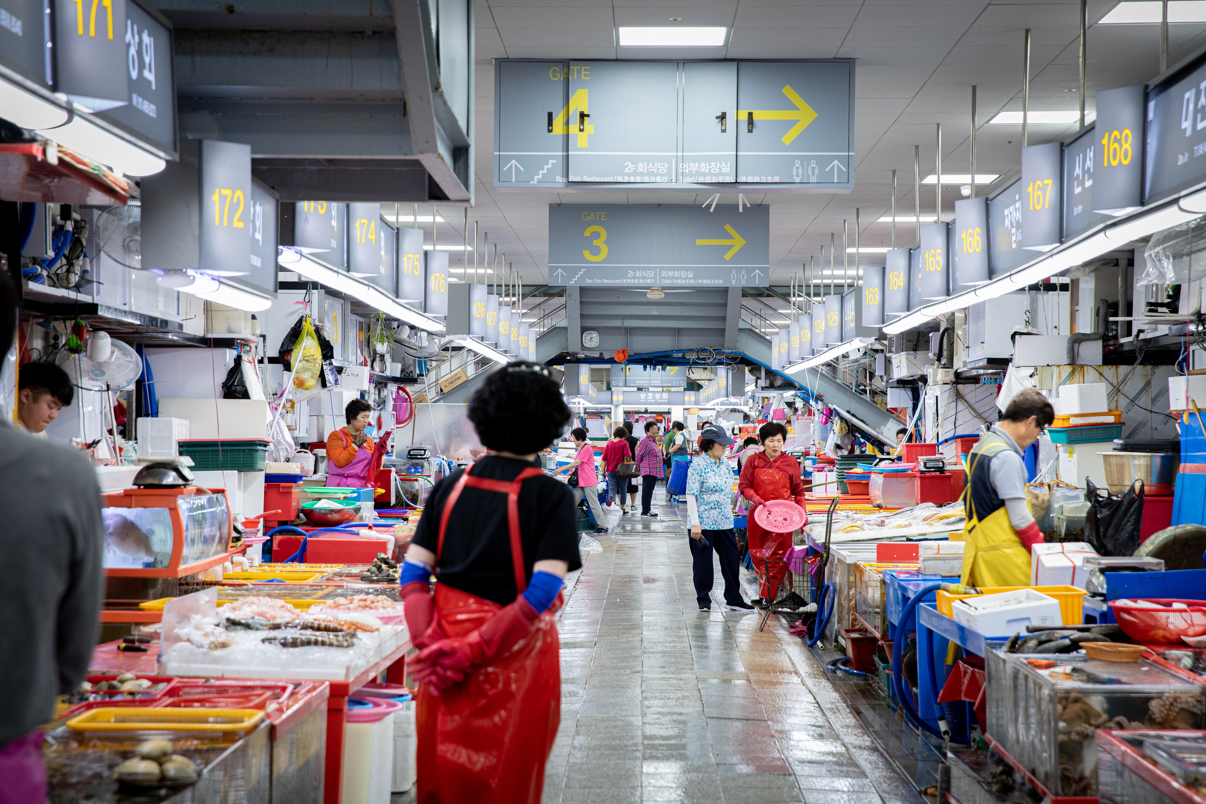 Wide view along a busy indoor food market