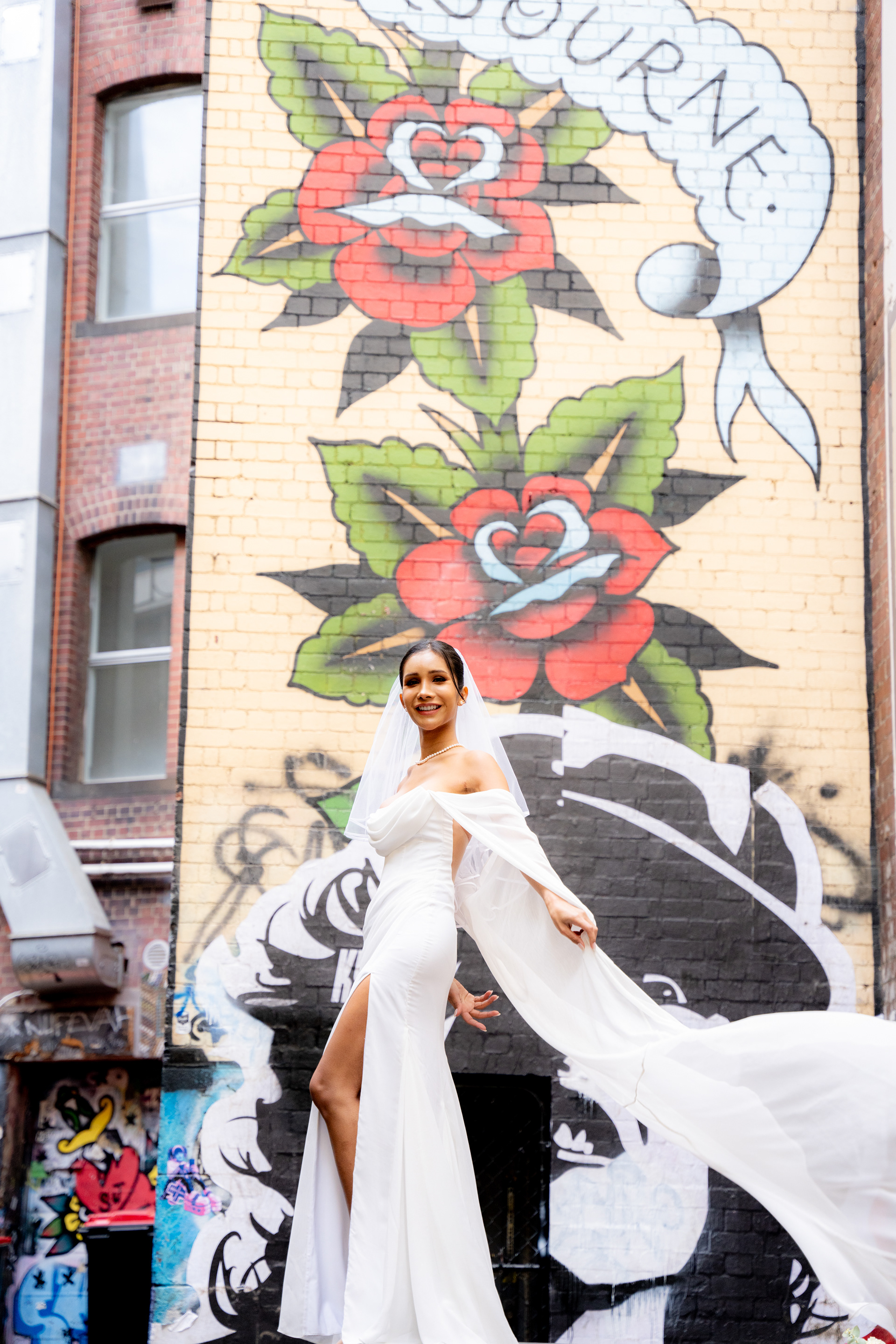 Wedding portrait beside a colourful street-art mural